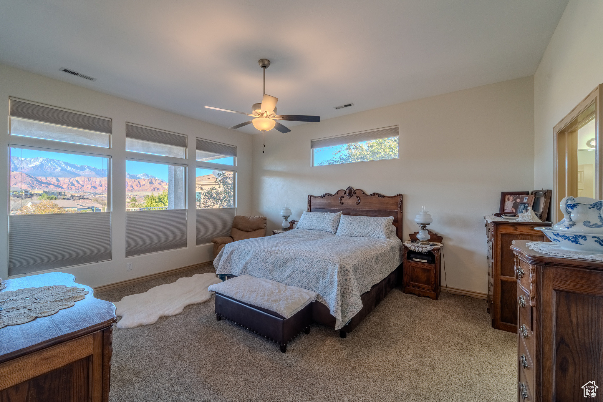 Carpeted bedroom with ceiling fan