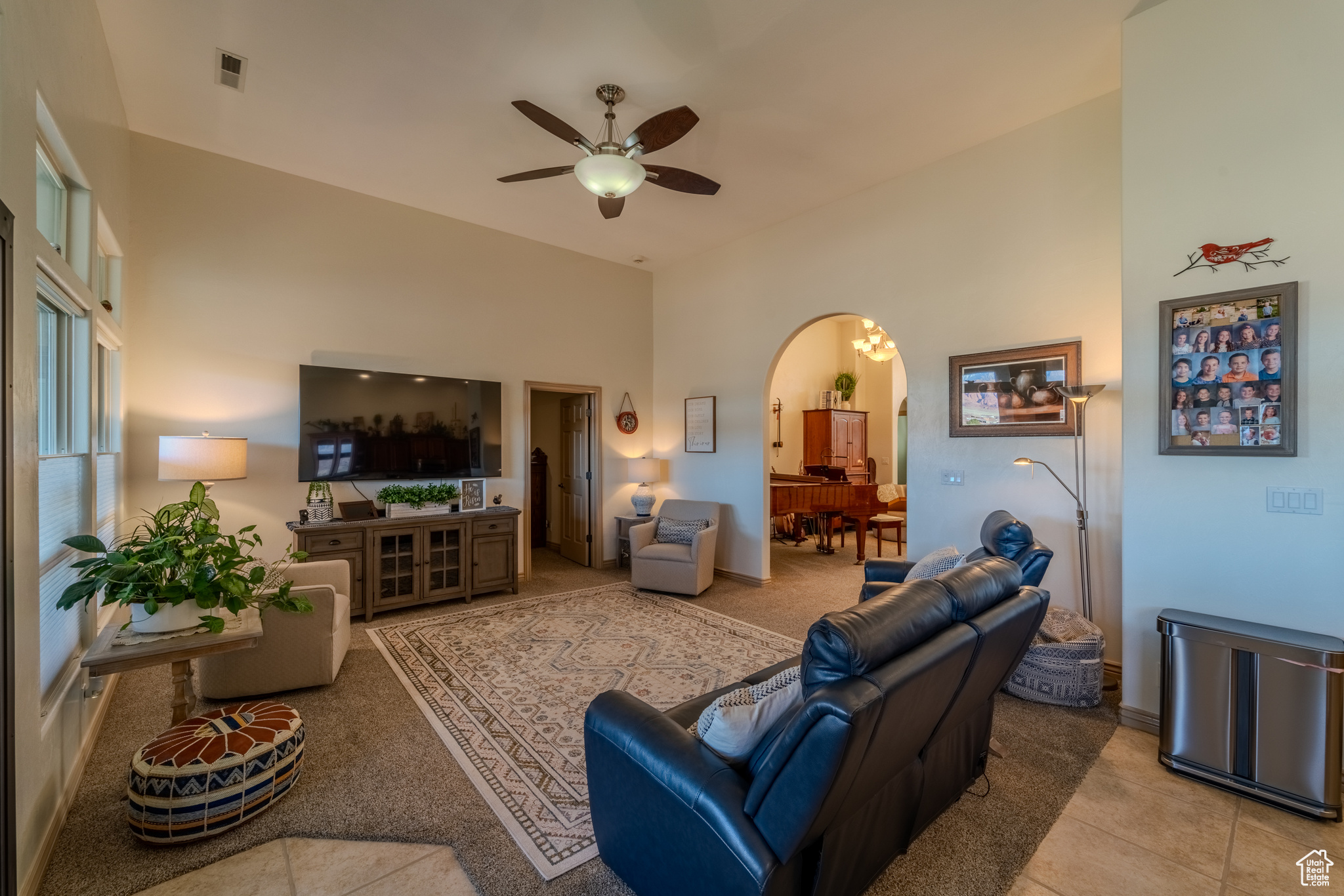 Living room featuring ceiling fan and light tile patterned floors