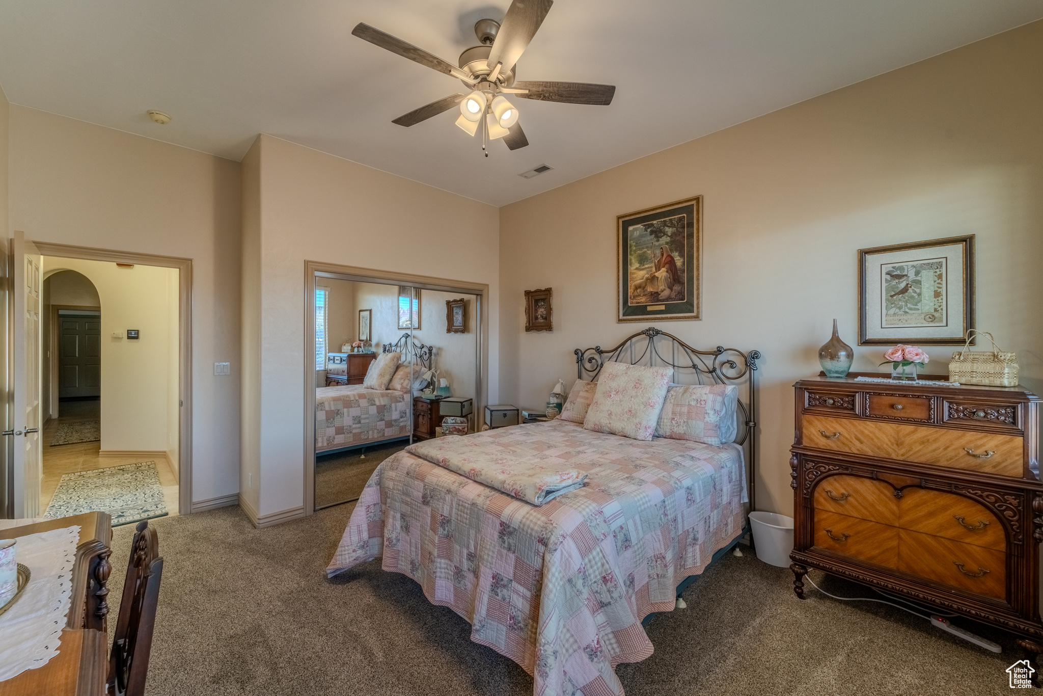 Bedroom featuring a closet, ceiling fan, and carpet flooring