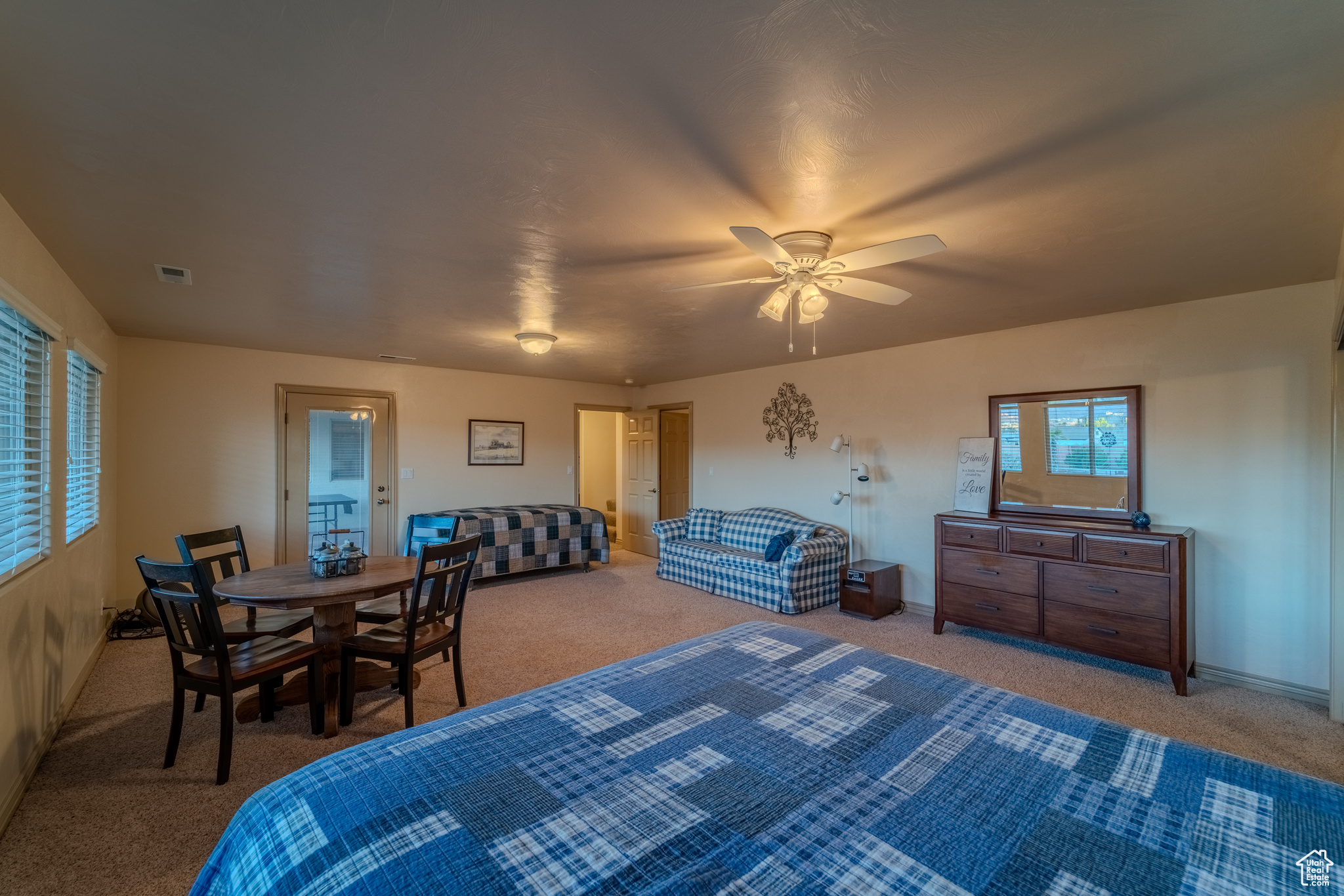 Bedroom featuring ceiling fan and carpet