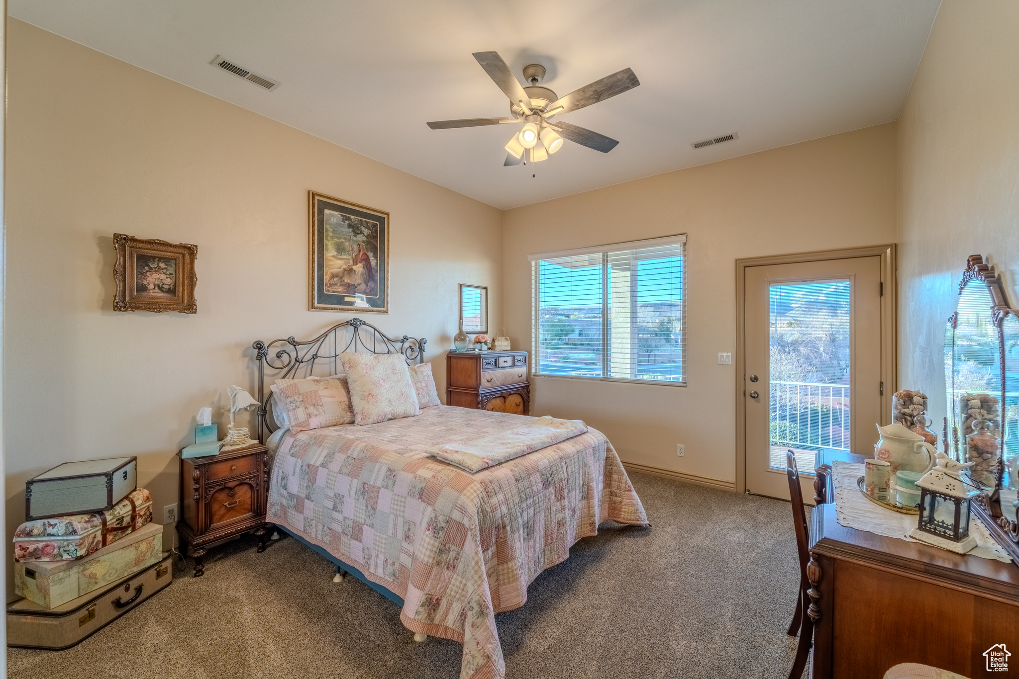 Bedroom featuring dark colored carpet, access to exterior, and ceiling fan