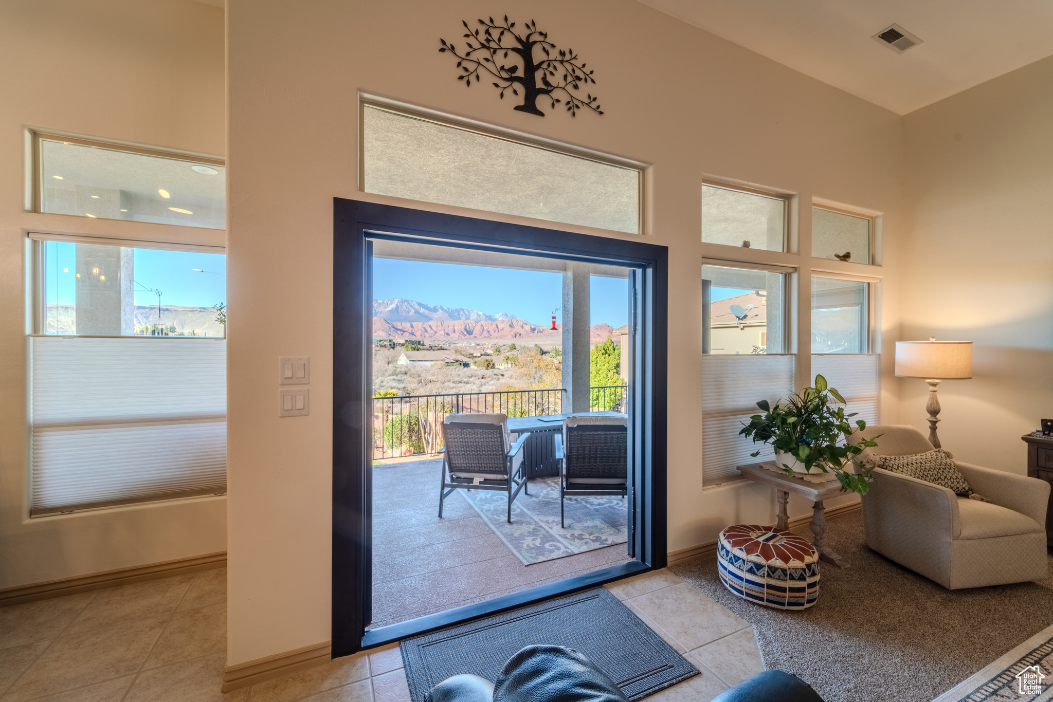 Doorway to outside with a wealth of natural light and light tile patterned floors