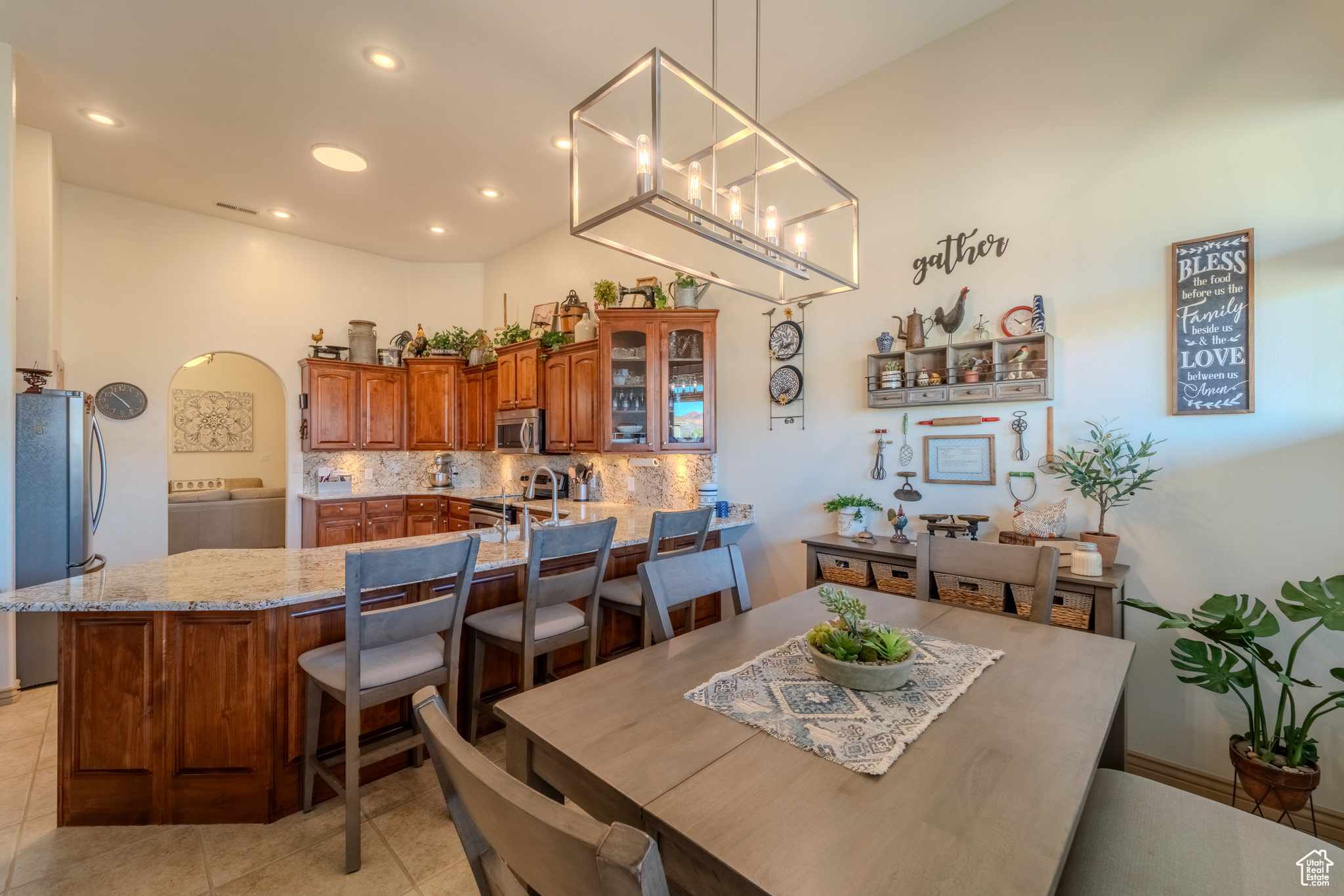 Dining space featuring a towering ceiling and light tile patterned flooring