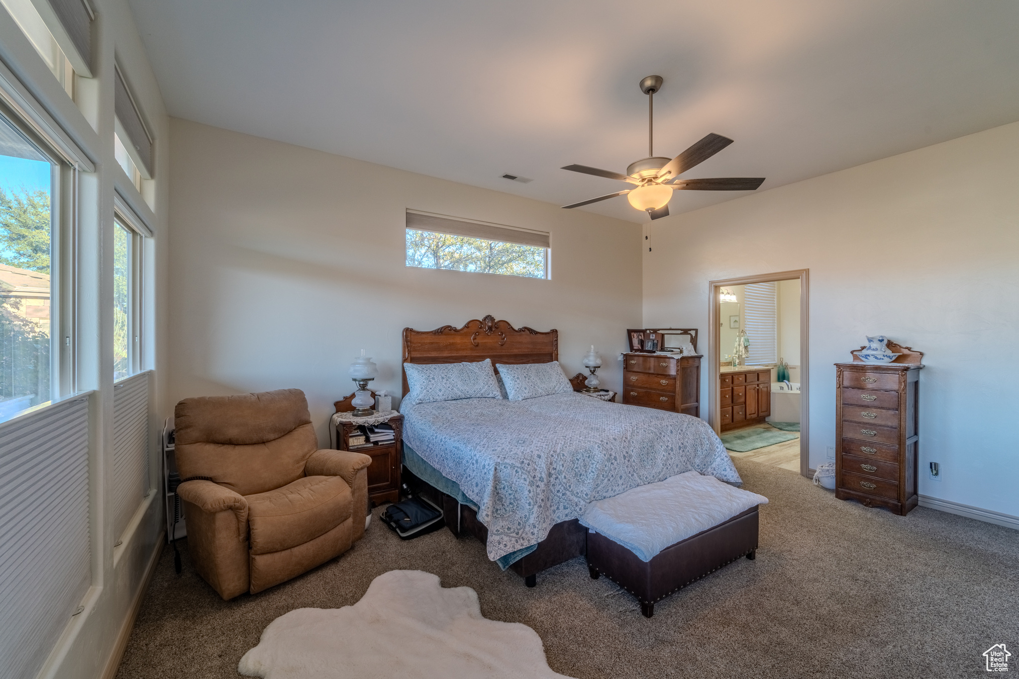 Bedroom with carpet, ceiling fan, and ensuite bathroom