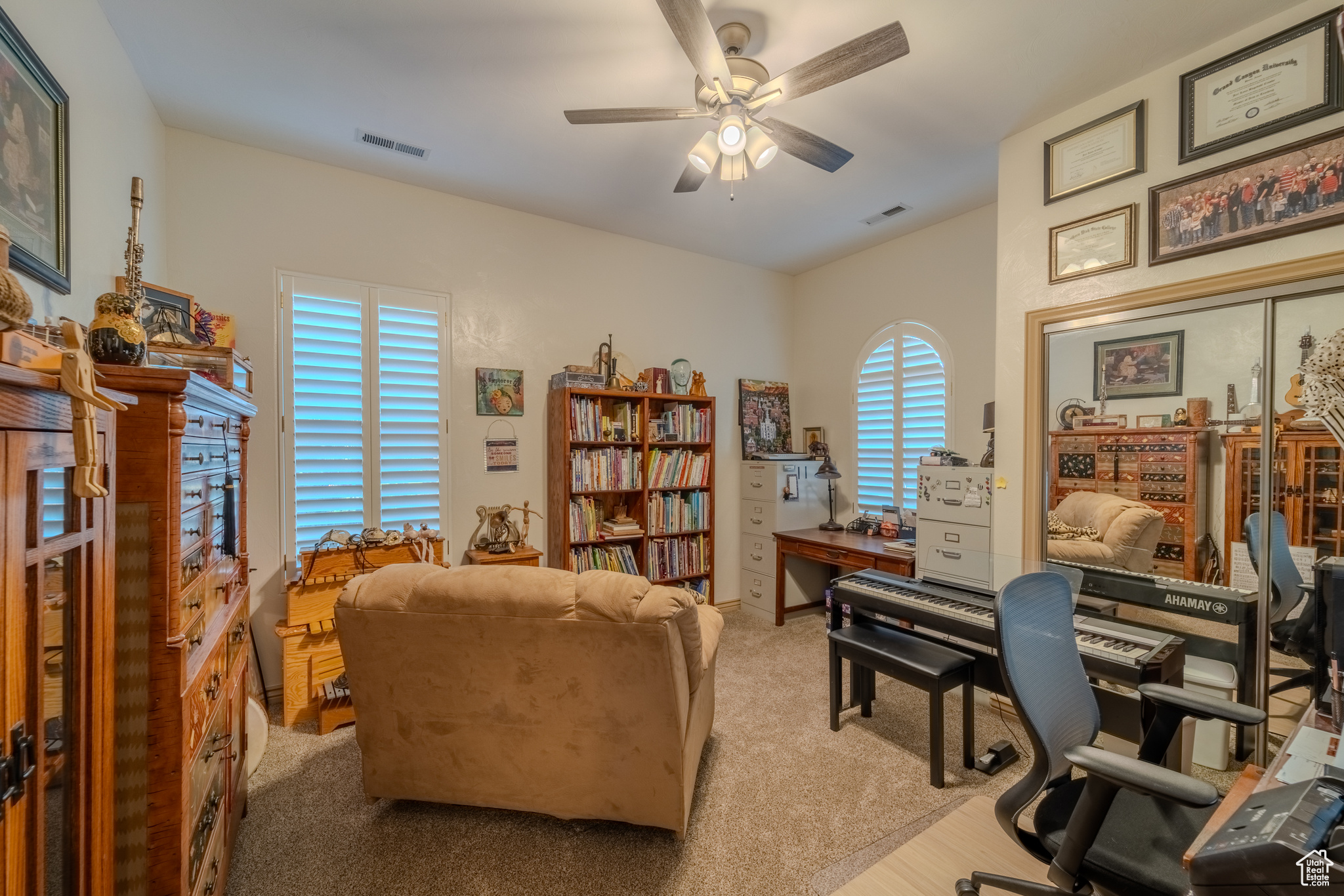 Carpeted office with ceiling fan