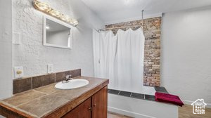 Bathroom with vanity and shower / tub combo