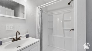 Bathroom featuring vanity and walk in shower