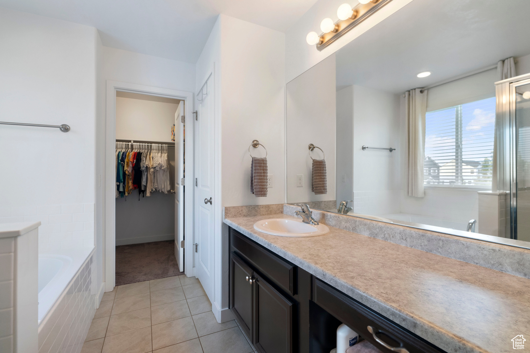 Bathroom featuring vanity, separate shower and tub, and tile patterned floors