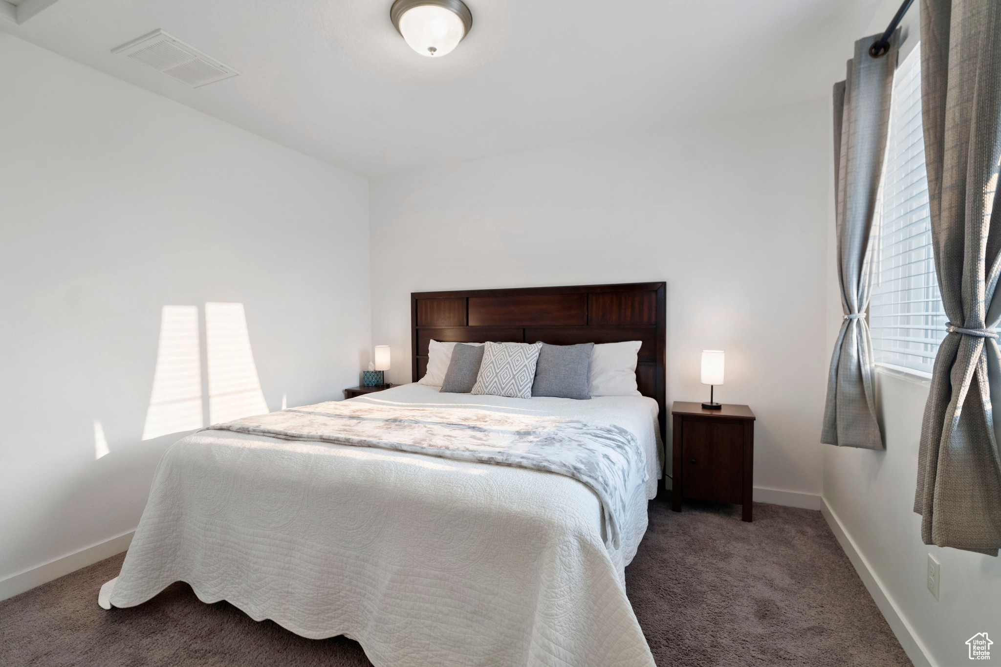 Bedroom featuring dark carpet