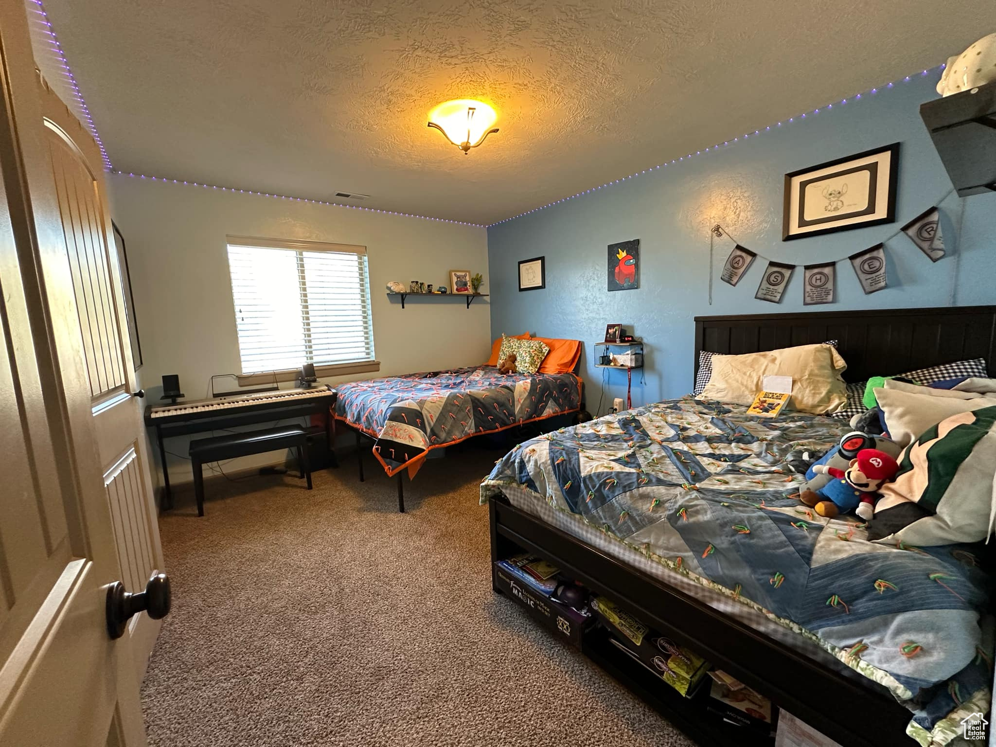 Carpeted bedroom with a textured ceiling