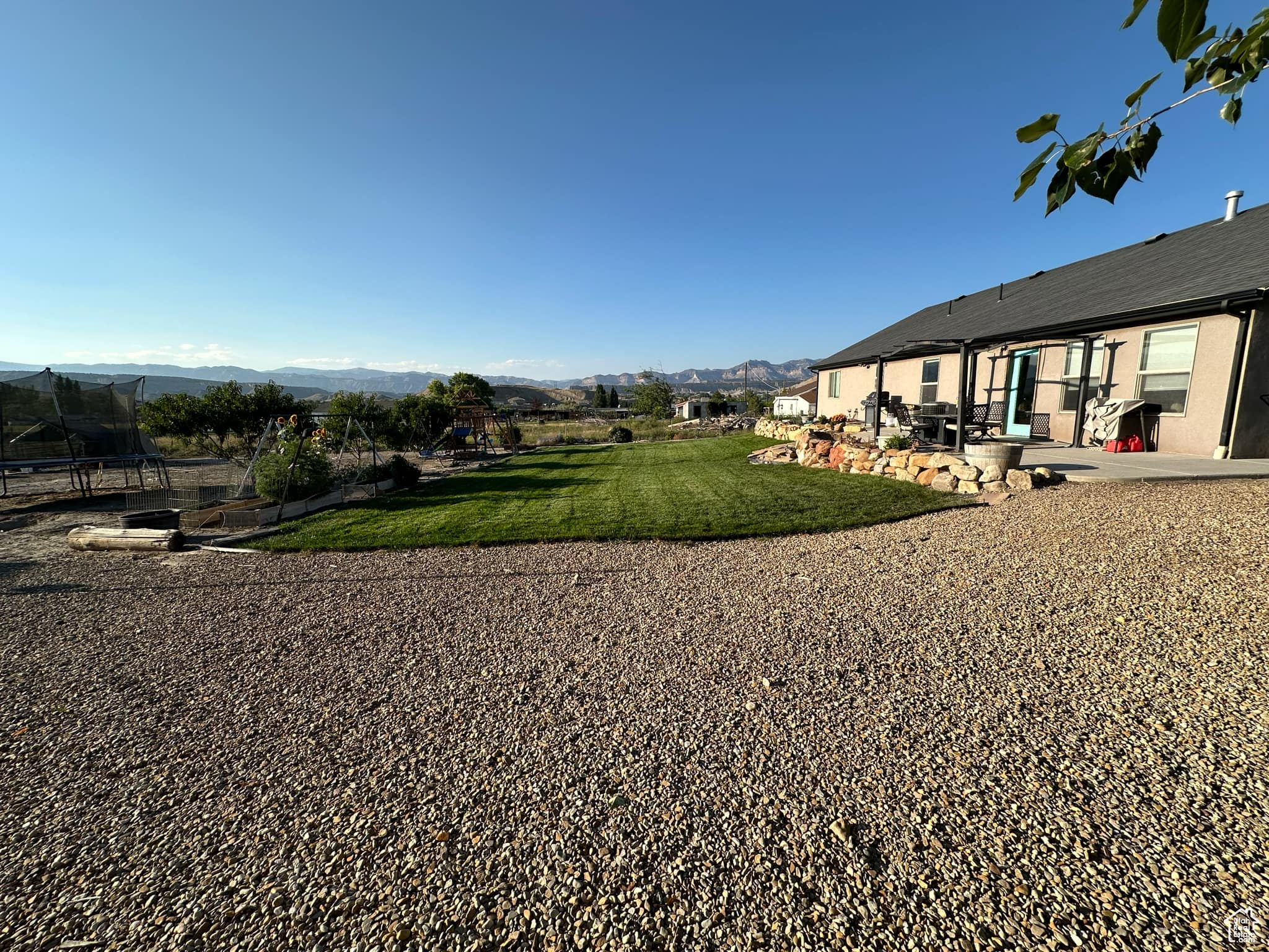 View of yard featuring a mountain view and a patio