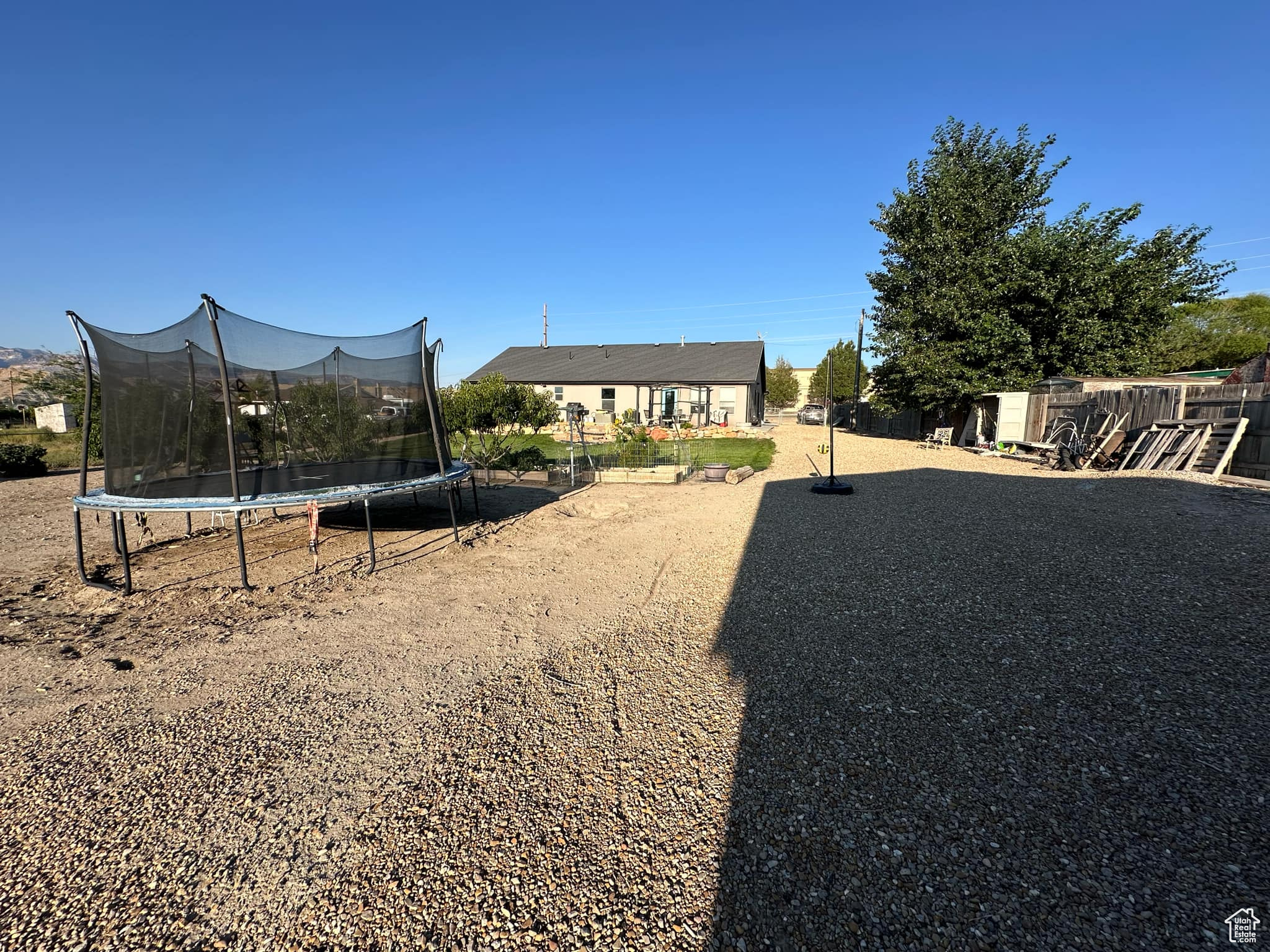 View of yard with a shed and a trampoline