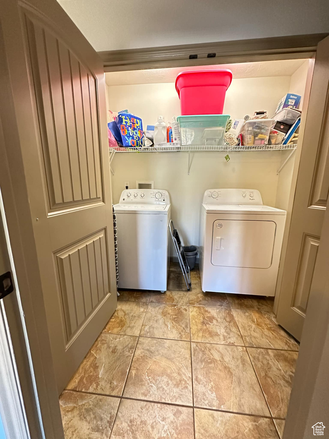 Clothes washing area featuring washer and dryer