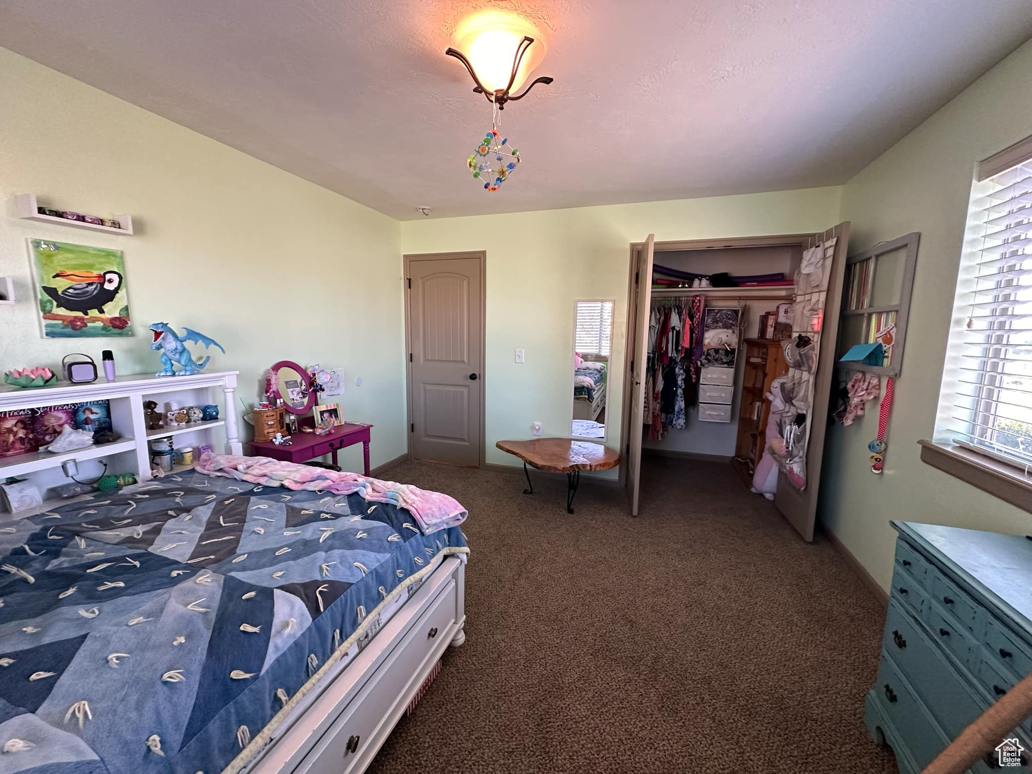 Carpeted bedroom with a closet