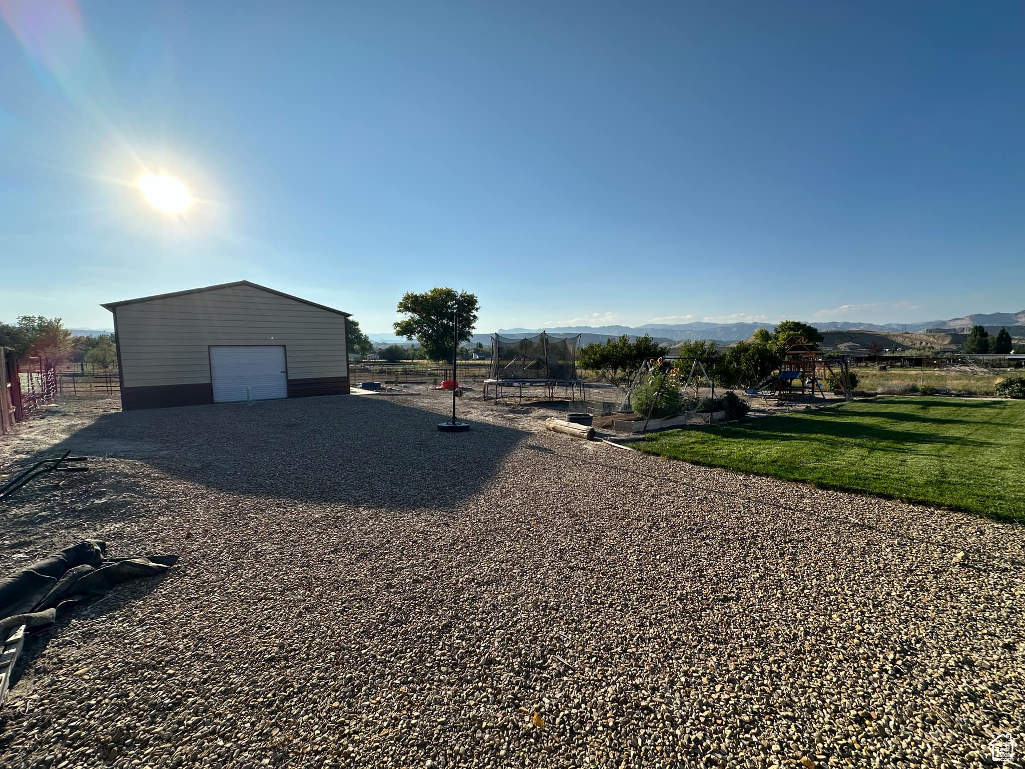 View of yard featuring a mountain view, a garage, and an outdoor structure