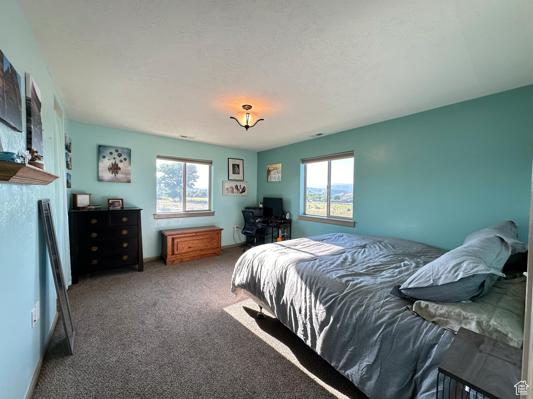 Bedroom with a textured ceiling and carpet floors