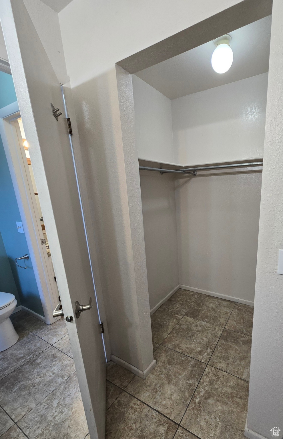 Spacious closet with tile patterned floors