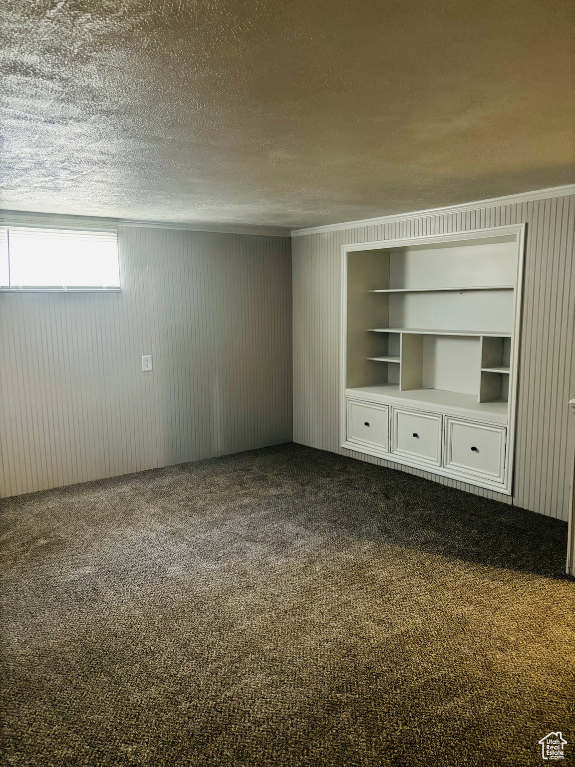 Interior space with carpet and a textured ceiling