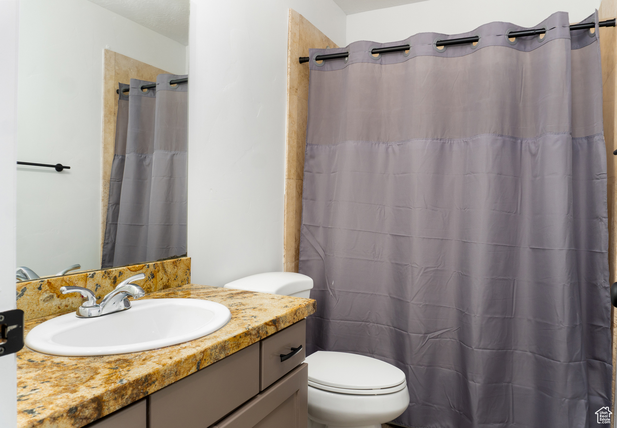 Bathroom with vanity, toilet, and walk in shower