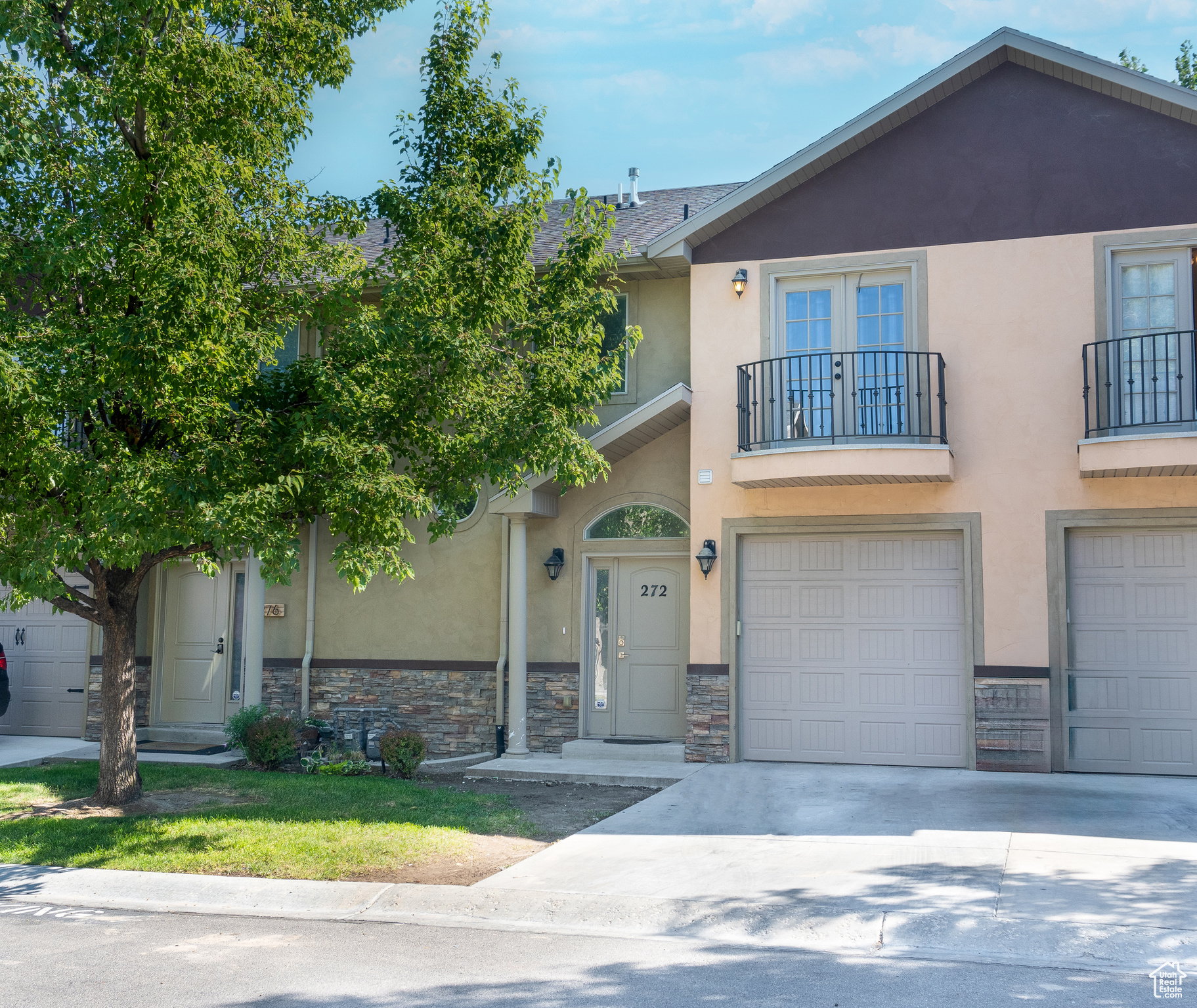 Townhome / multi-family property with a balcony and a garage