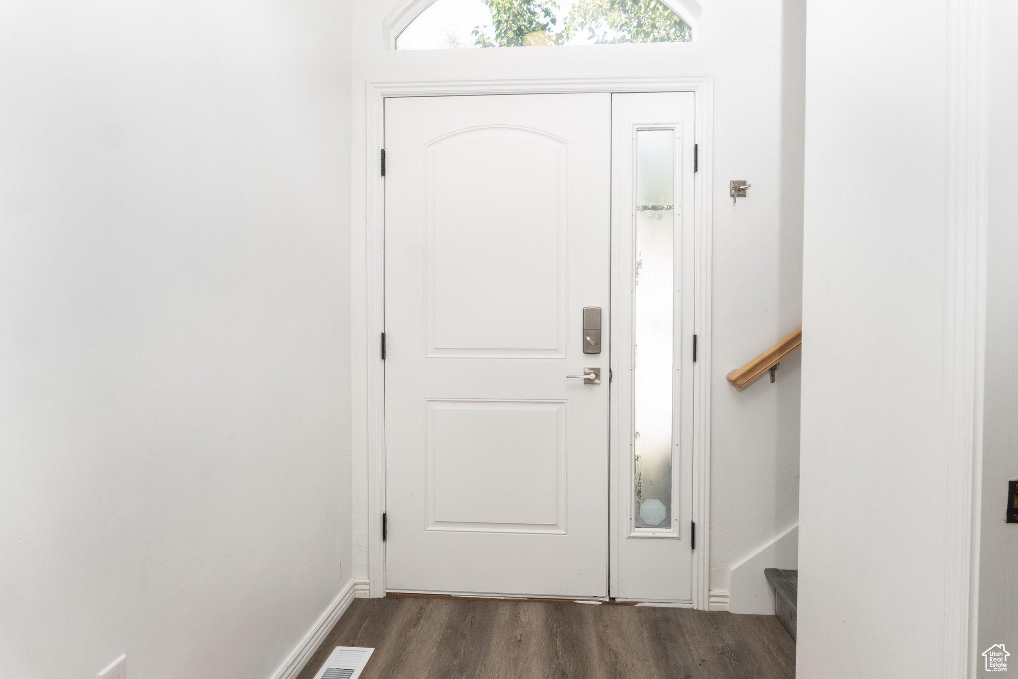 Entrance foyer featuring dark hardwood / wood-style floors