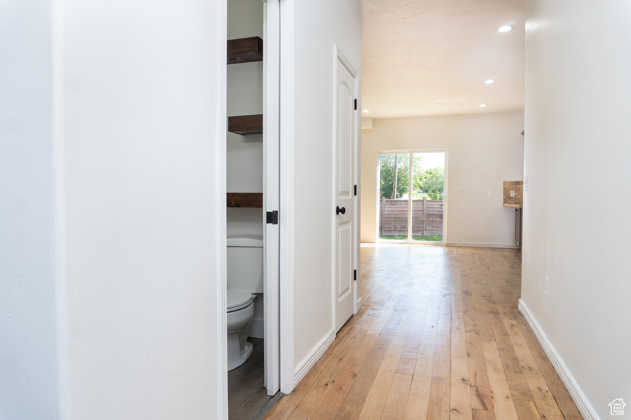 Corridor with light wood-type flooring