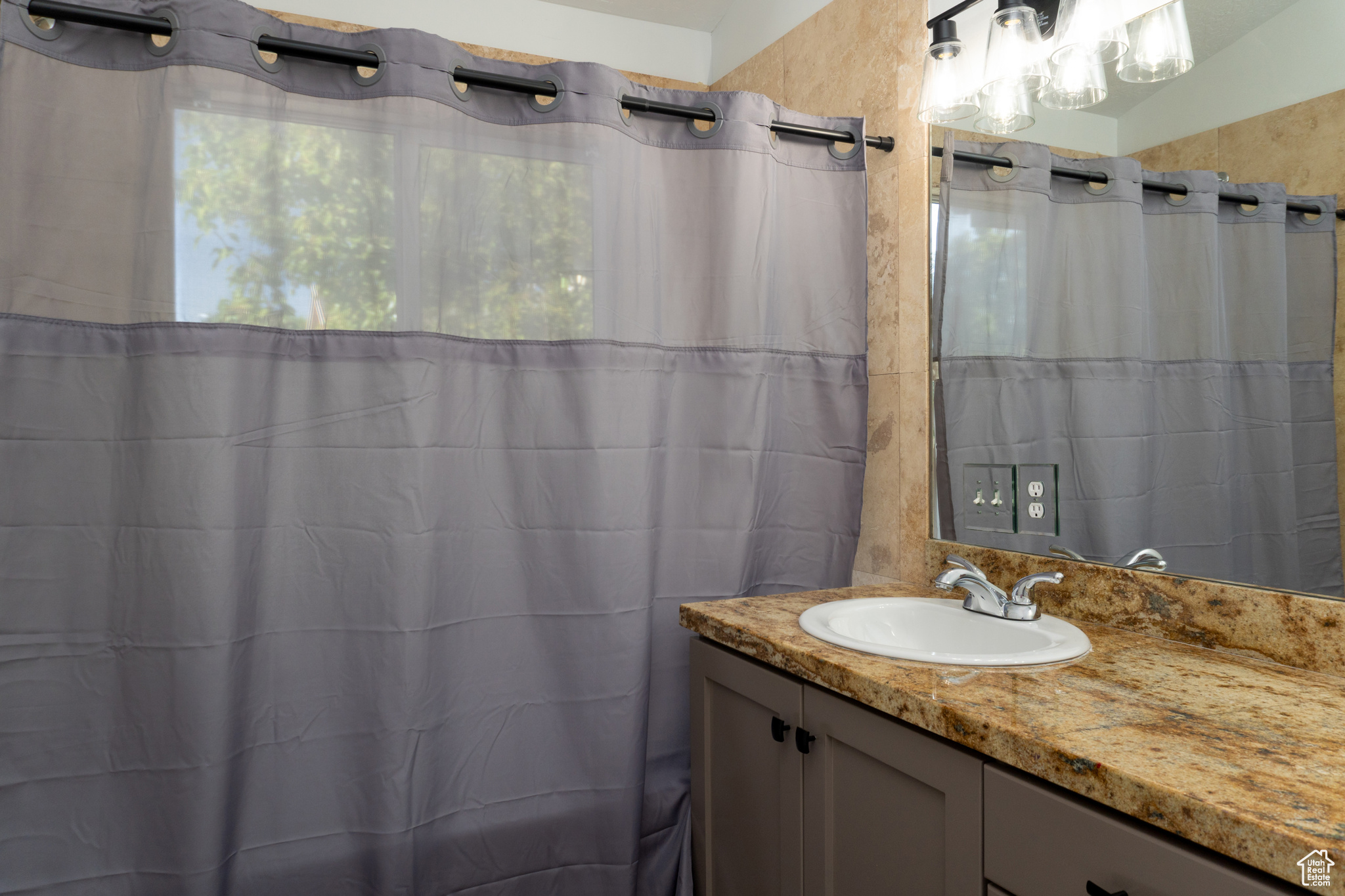 Master Bathroom with vanity and a shower with shower curtain