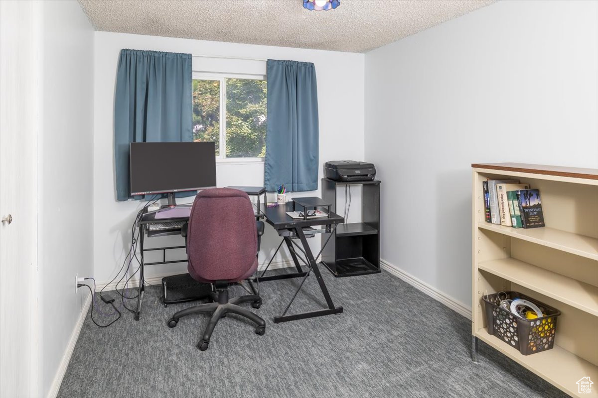 Bedroom featuring a textured ceiling and carpet floors