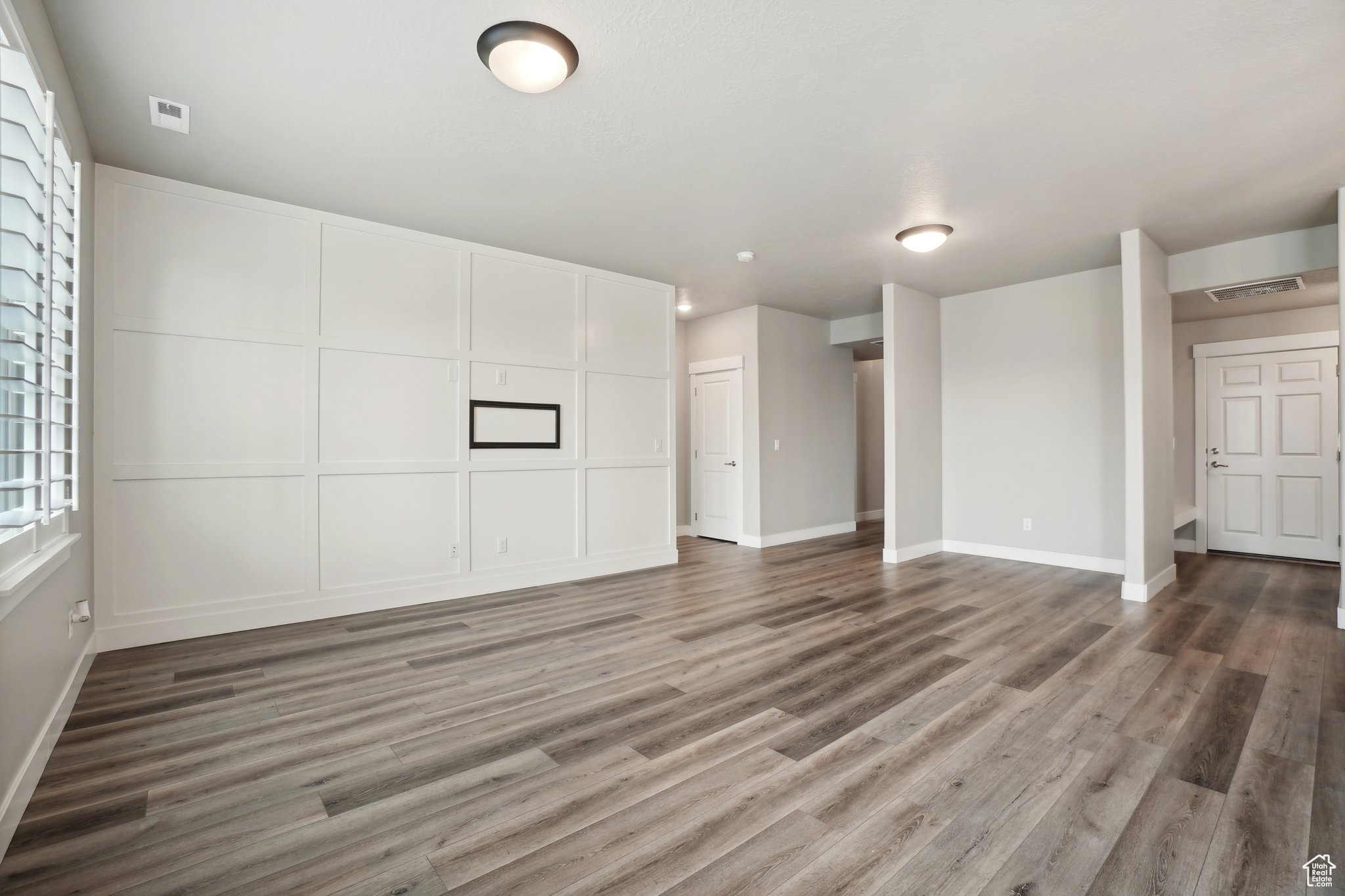 Unfurnished living room with hardwood / wood-style floors