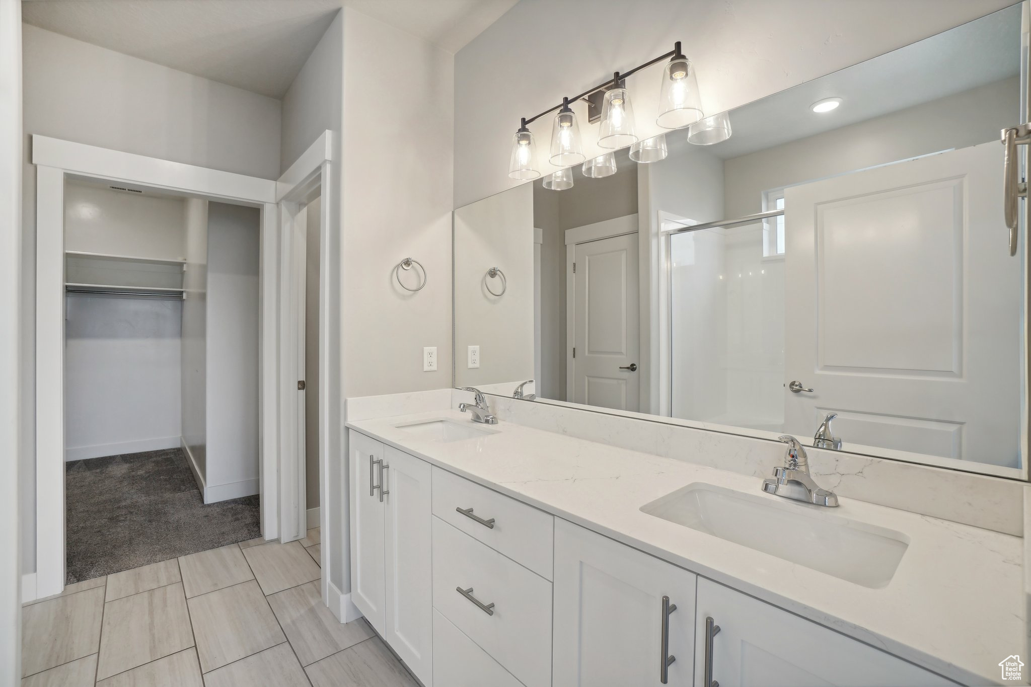 Bathroom featuring vanity and an enclosed shower