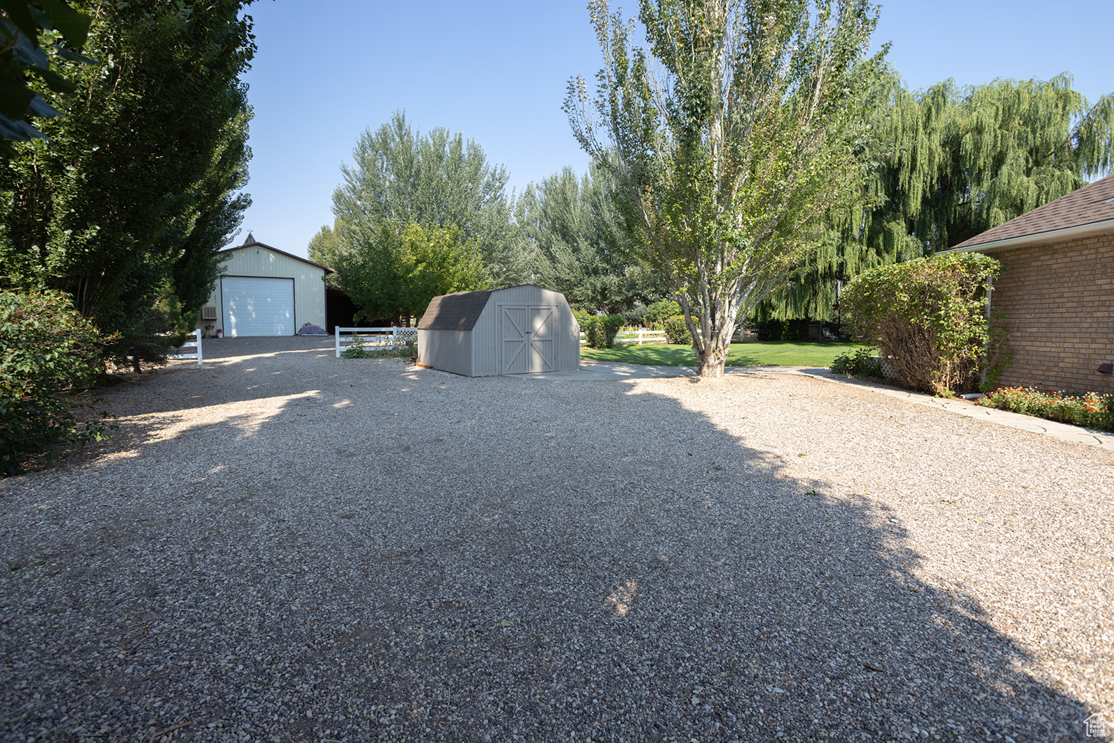 View of yard featuring a storage unit and a garage