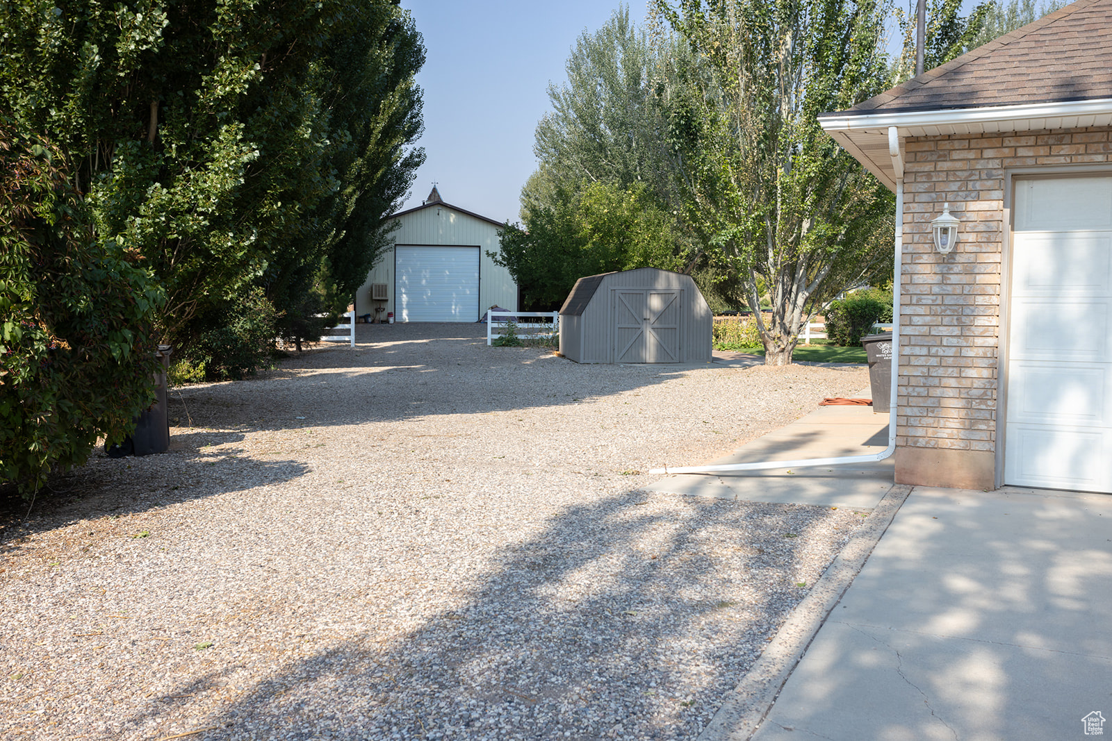 View of yard with a storage shed and a garage