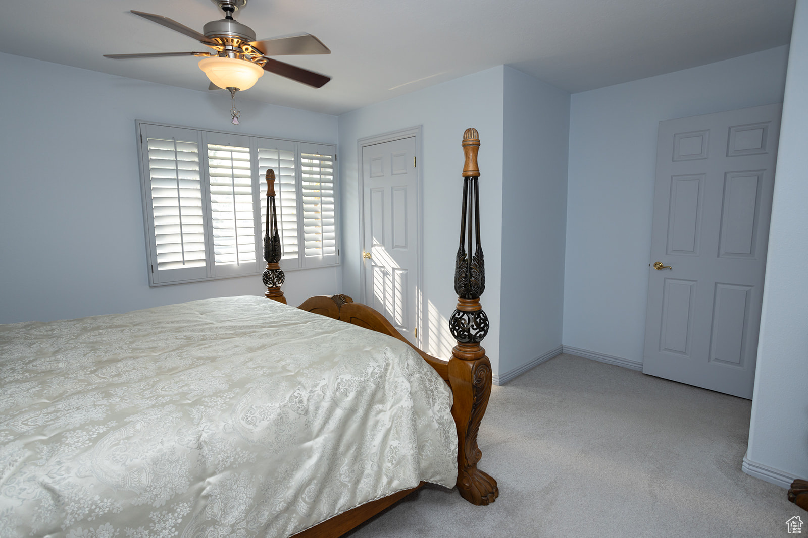 Carpeted bedroom with ceiling fan