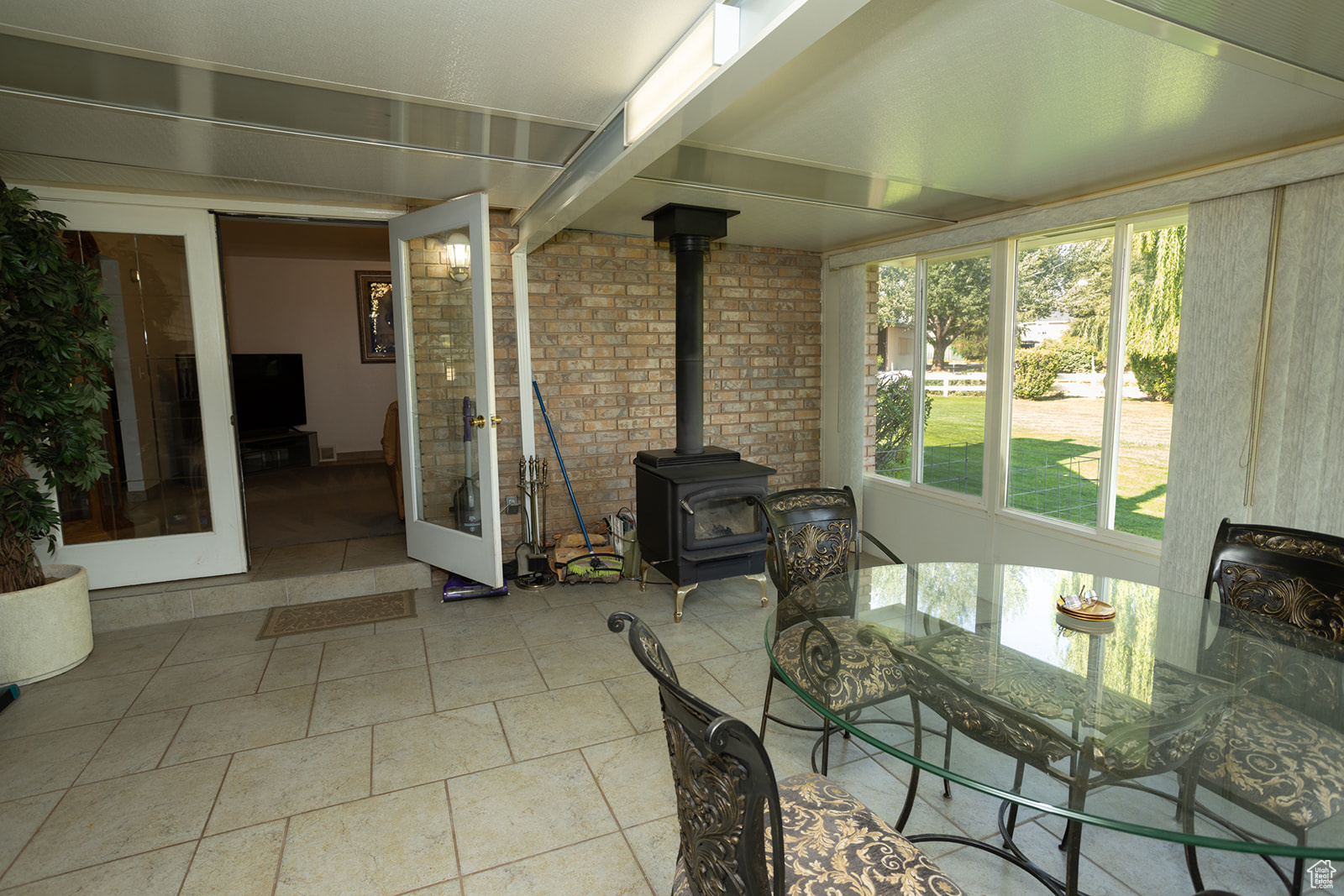 Sunroom featuring a wood stove