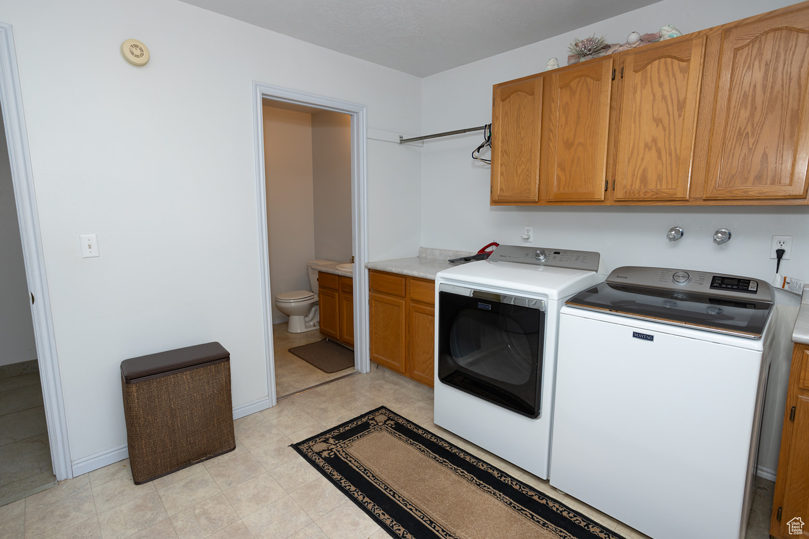 Washroom featuring washer and dryer and cabinets