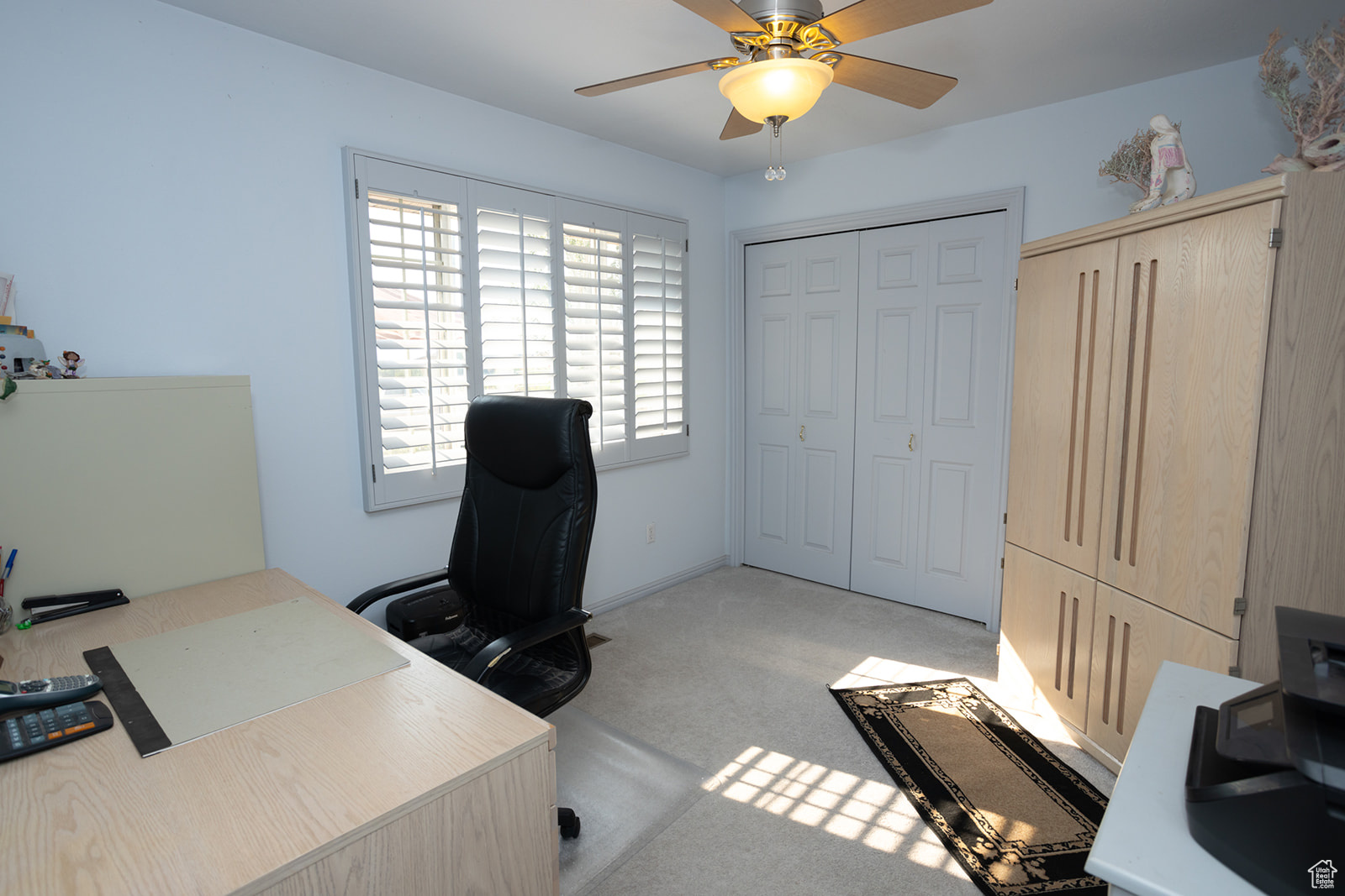 Office featuring ceiling fan and light carpet