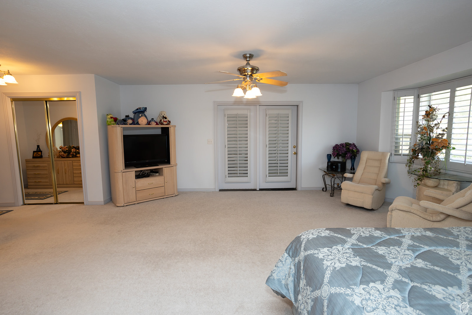 Carpeted bedroom with ceiling fan