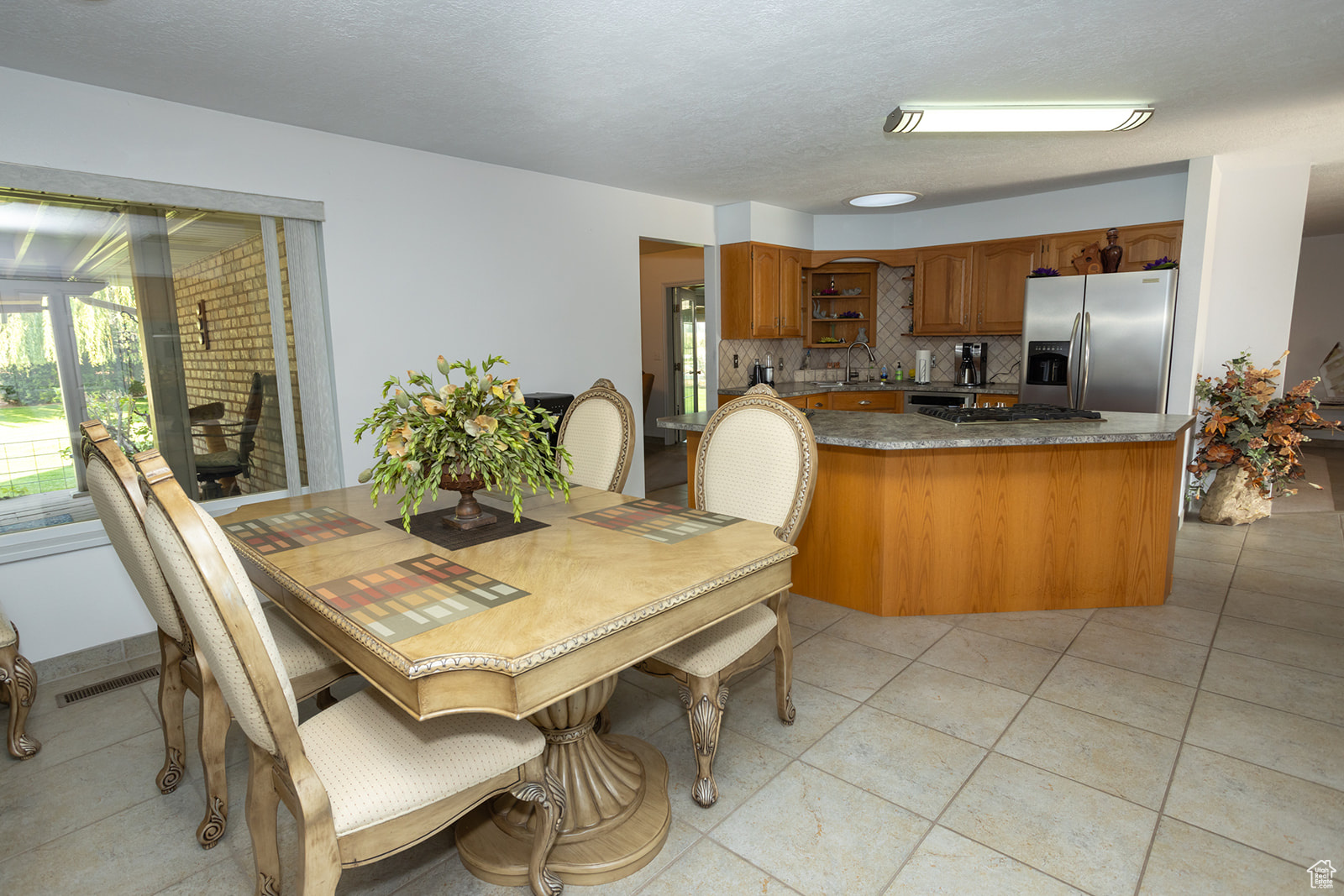 Tiled dining room with sink