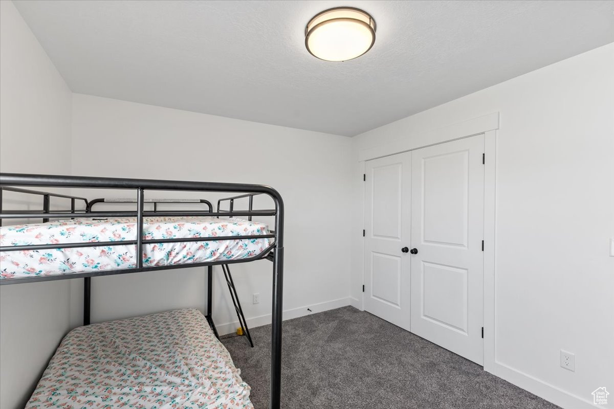 Bedroom featuring carpet flooring and a closet