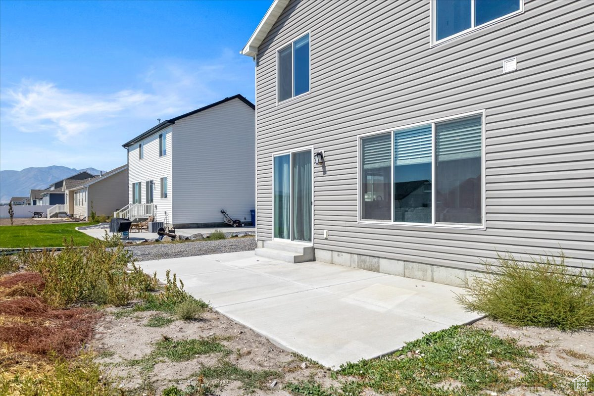 Rear view of property featuring a patio and a mountain view