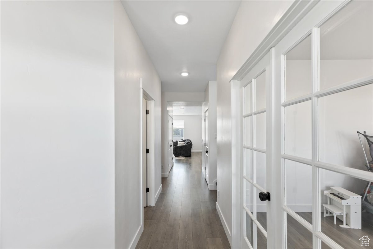 Hall with hardwood / wood-style floors