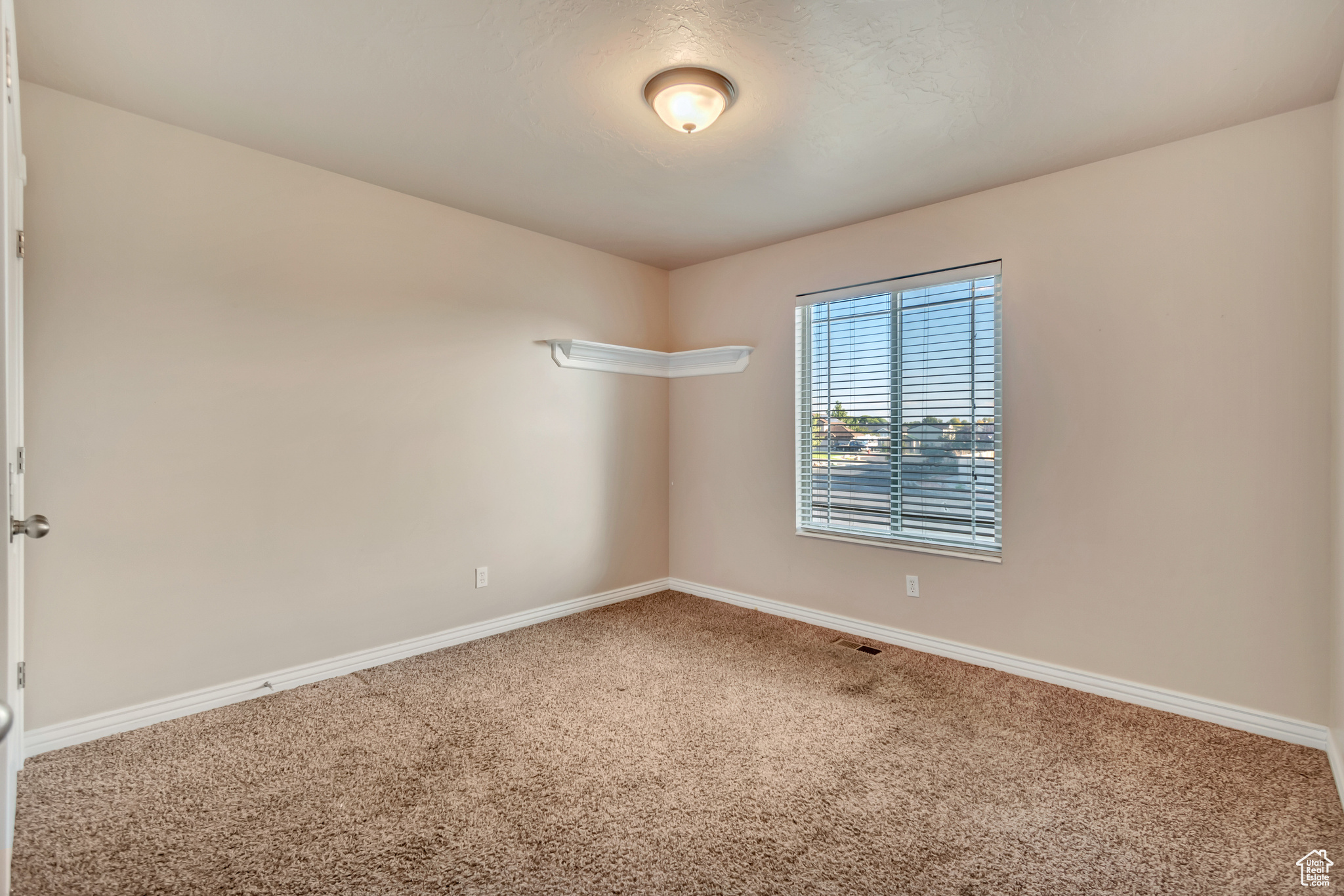 View of carpeted main level bedroom