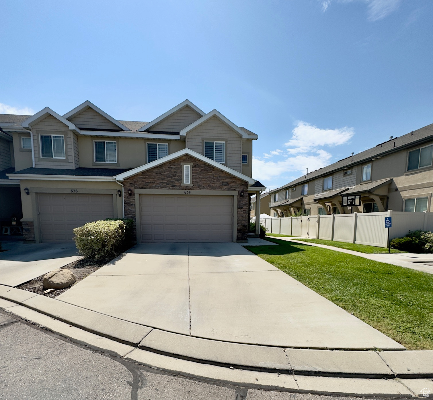 View of front of home with a long driveway & 2 car garage