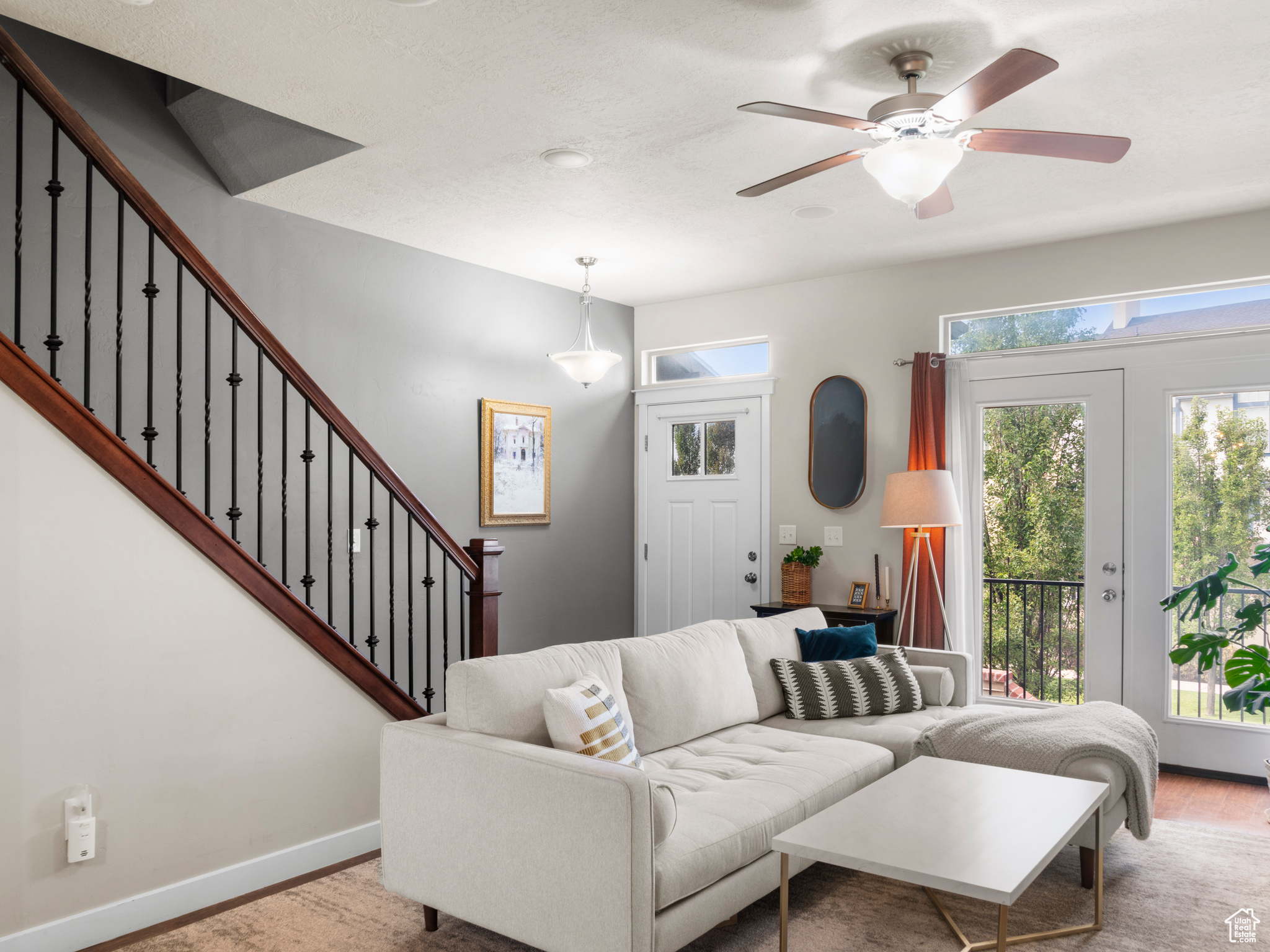 Living room featuring hardwood / wood-style flooring and ceiling fan