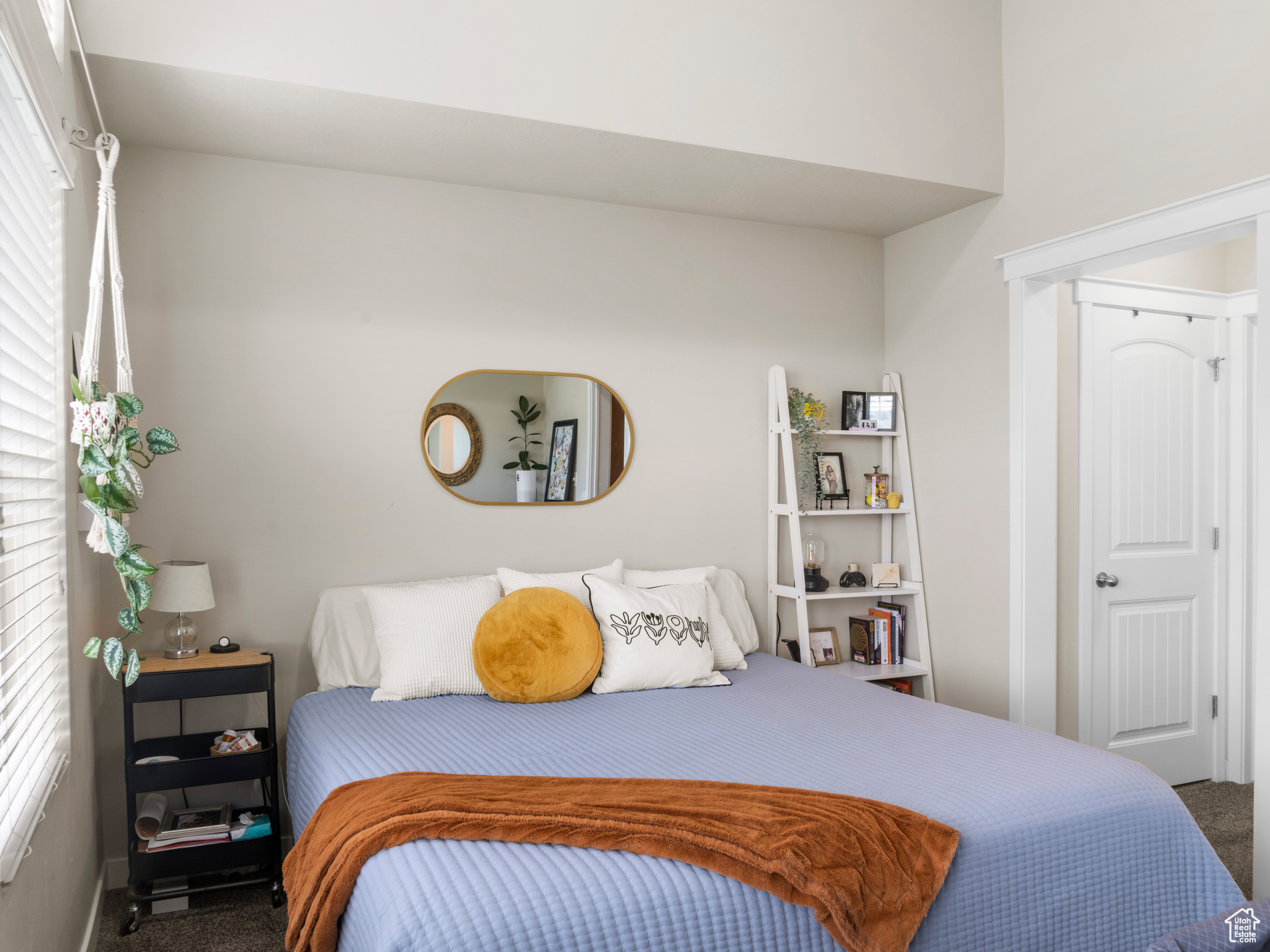 Bedroom featuring carpet flooring and multiple windows