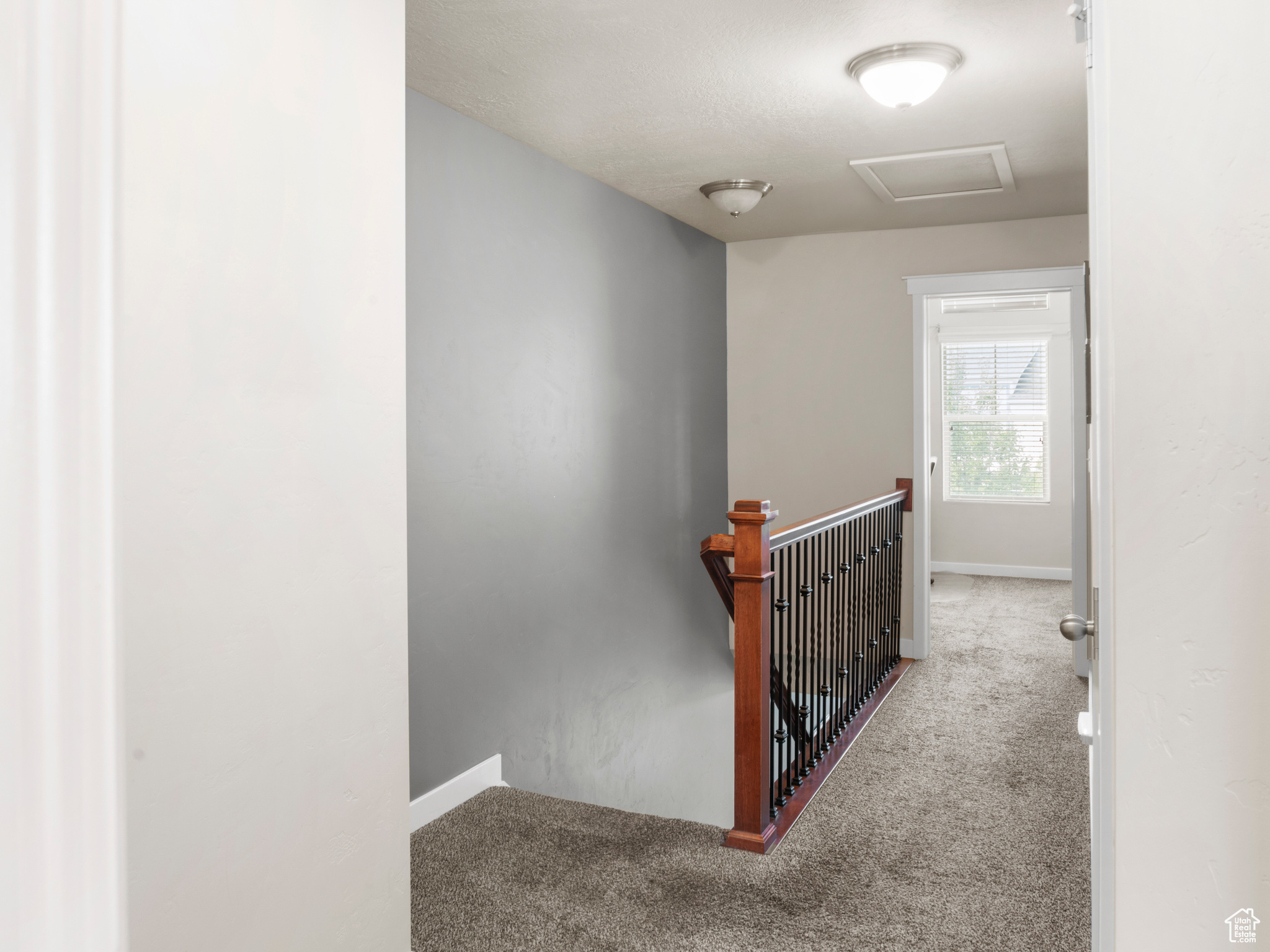 Corridor with light colored carpet