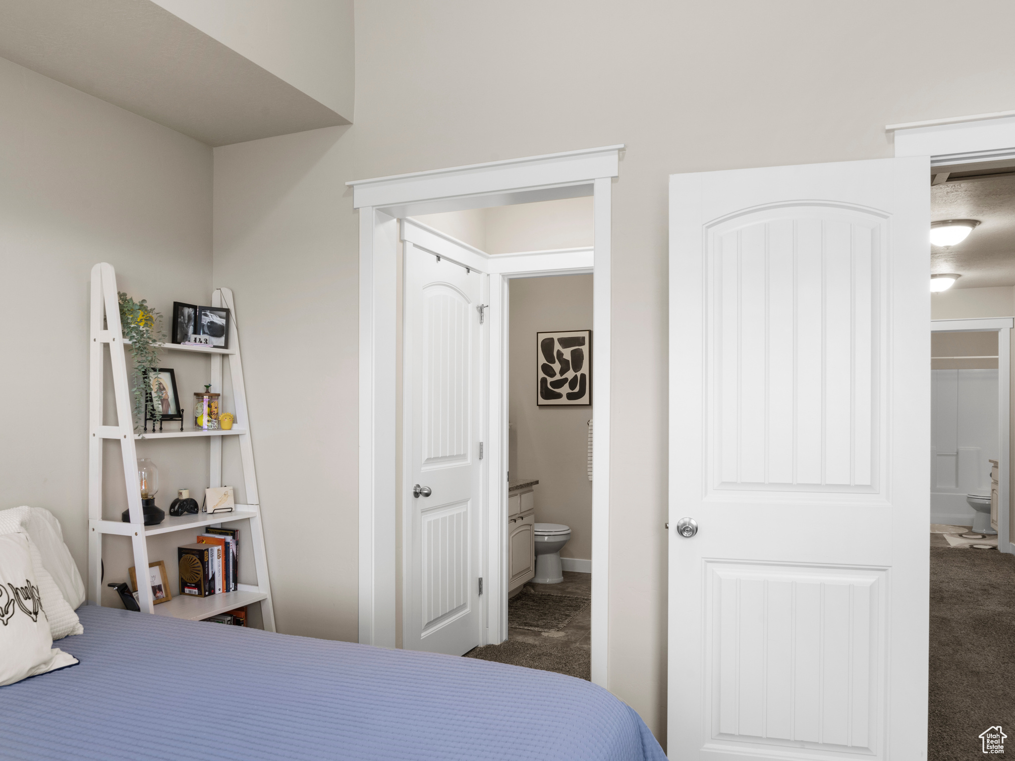 Bedroom featuring carpet flooring and ensuite bath