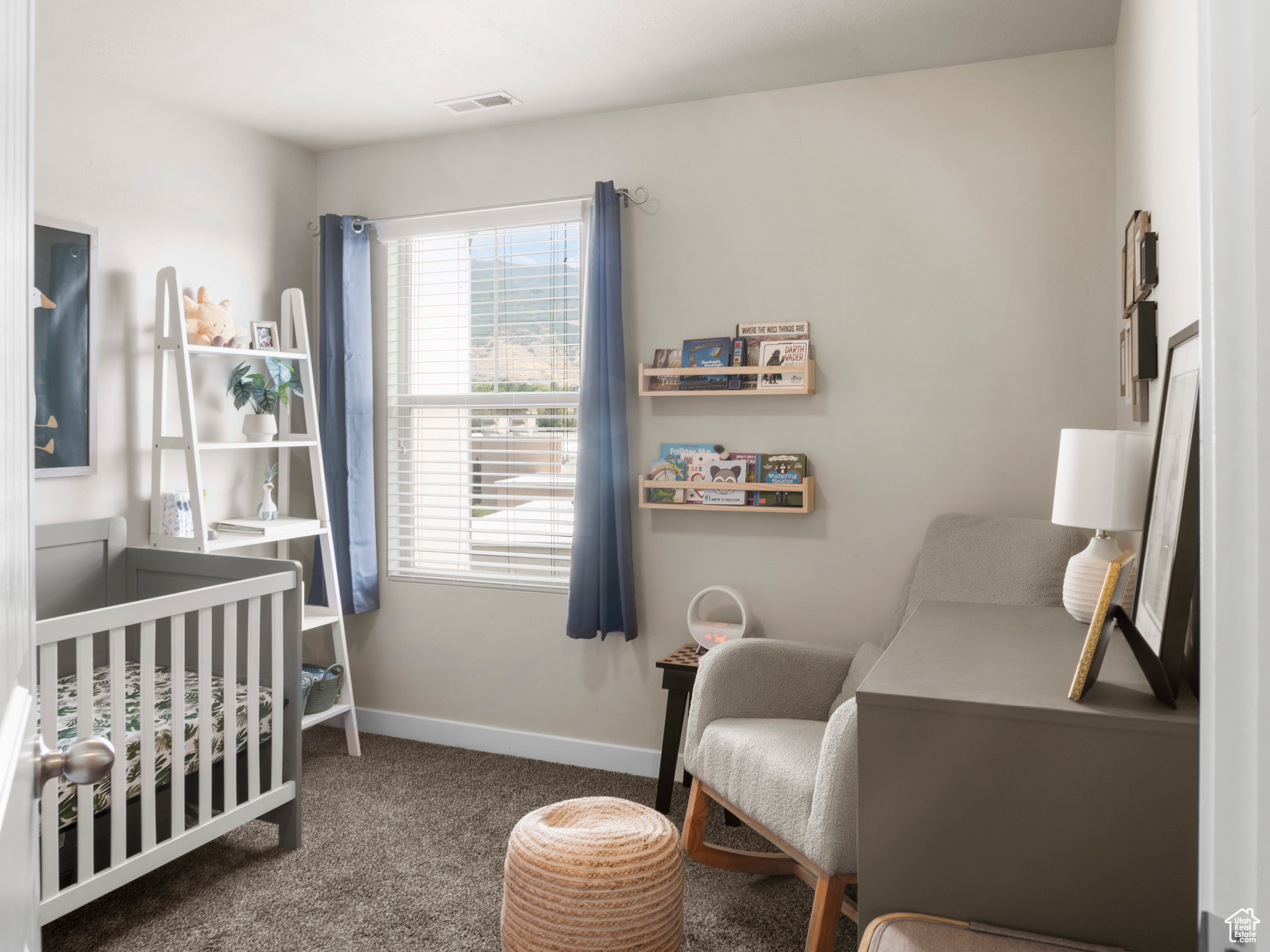 Carpeted bedroom with a crib