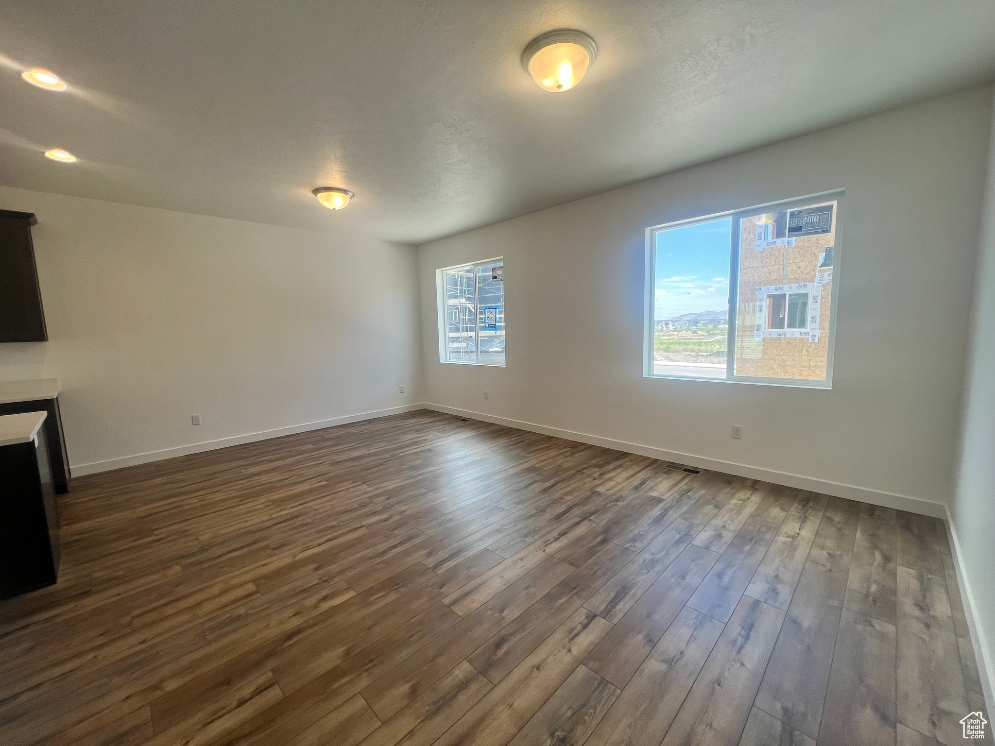 Unfurnished living room with dark hardwood / wood-style flooring