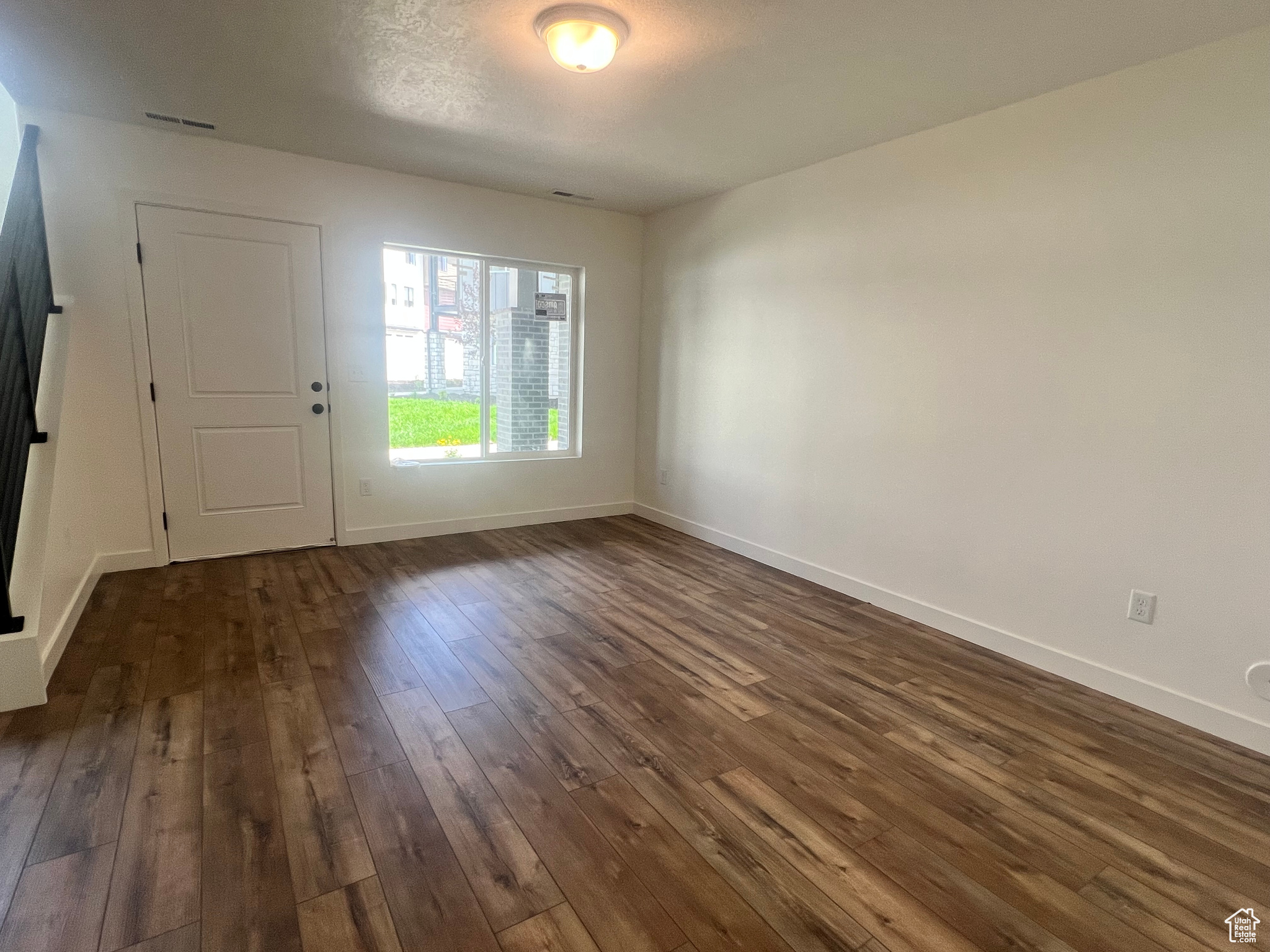 Foyer entrance with dark hardwood / wood-style floors